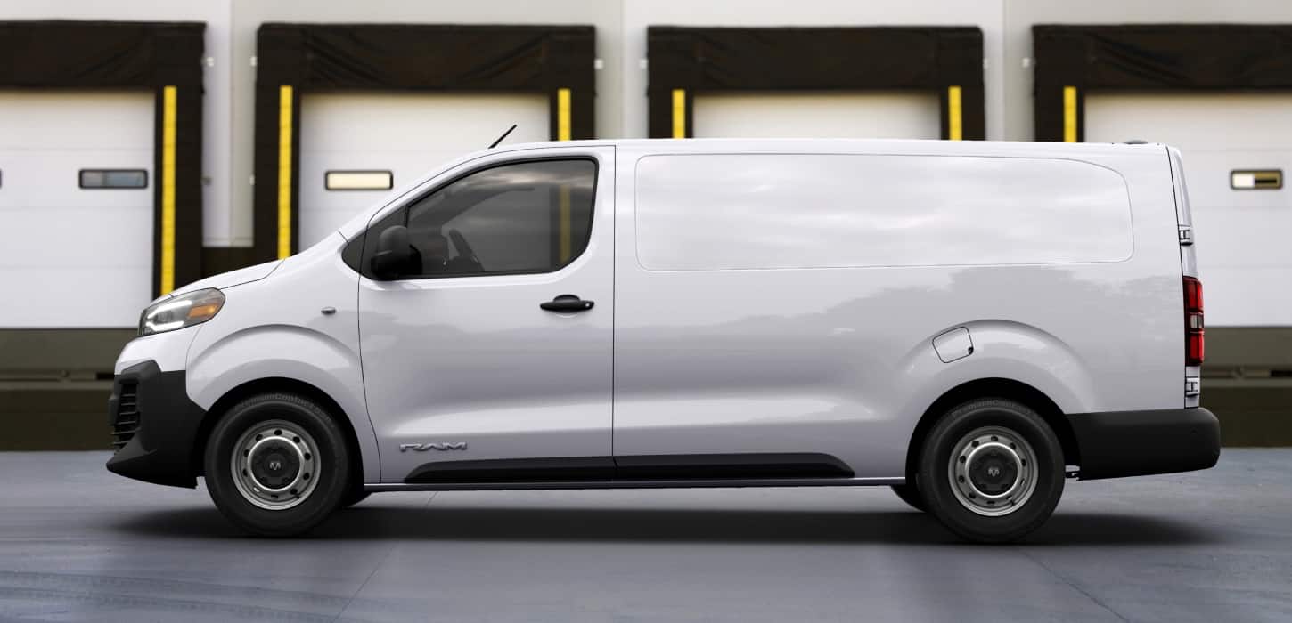 White 2027 Ram ProMaster City Cargo Van, driver side profile at a loading dock
