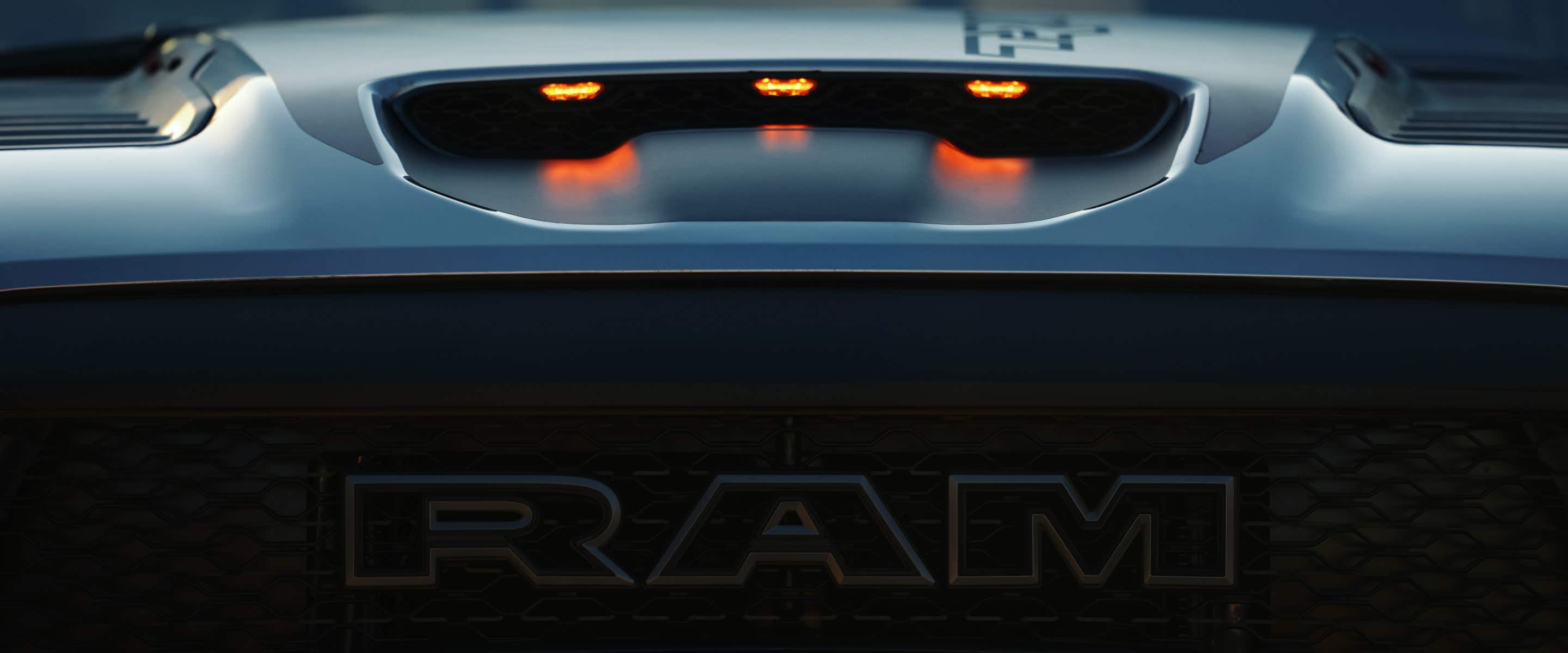 A close-up of the front grille and Ram badge on the 2021 Ram 1500 TRX.