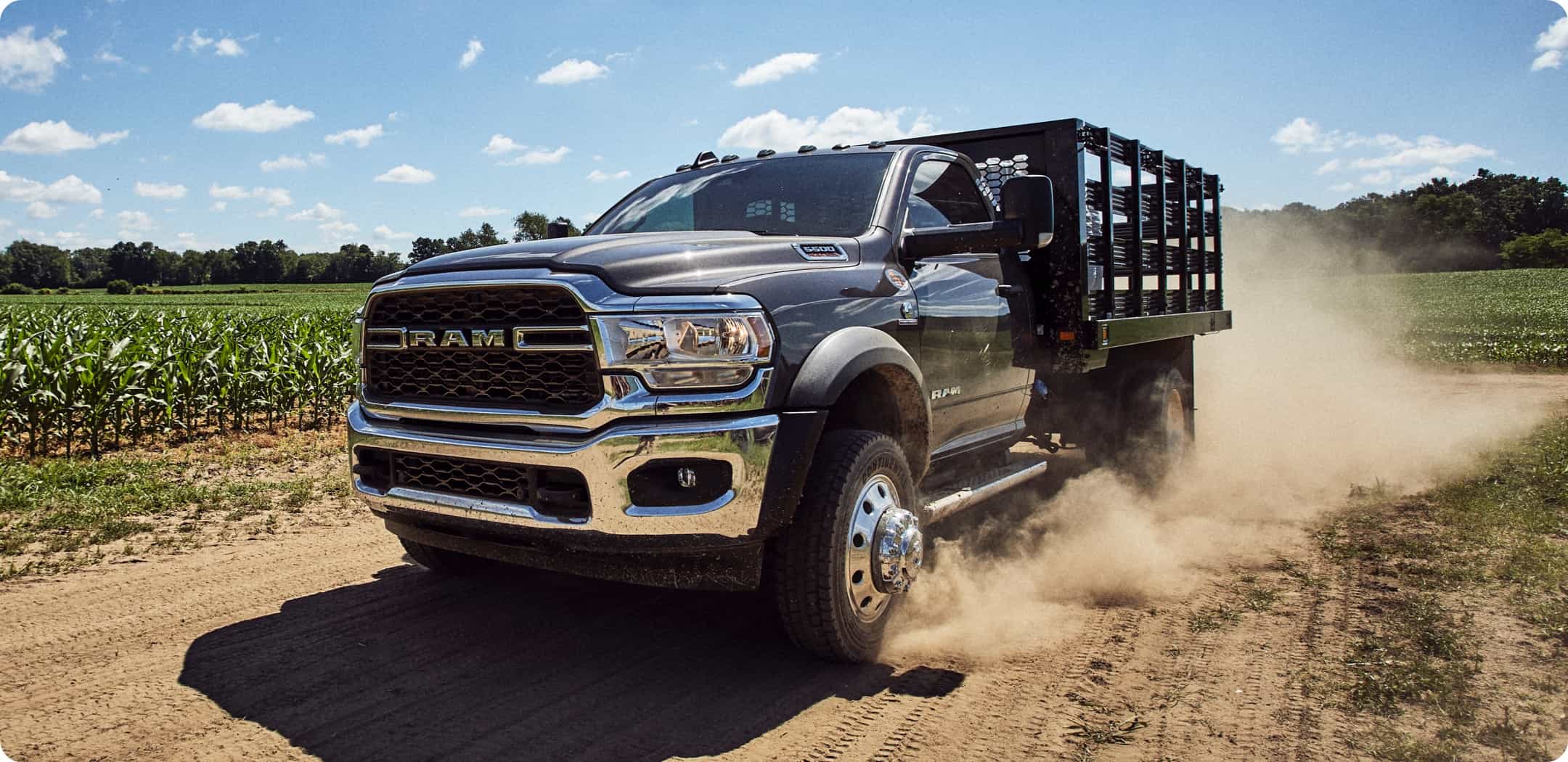 Display The 2021 Ram Chassis Cab with a cage upfit being driven on a dirt road.