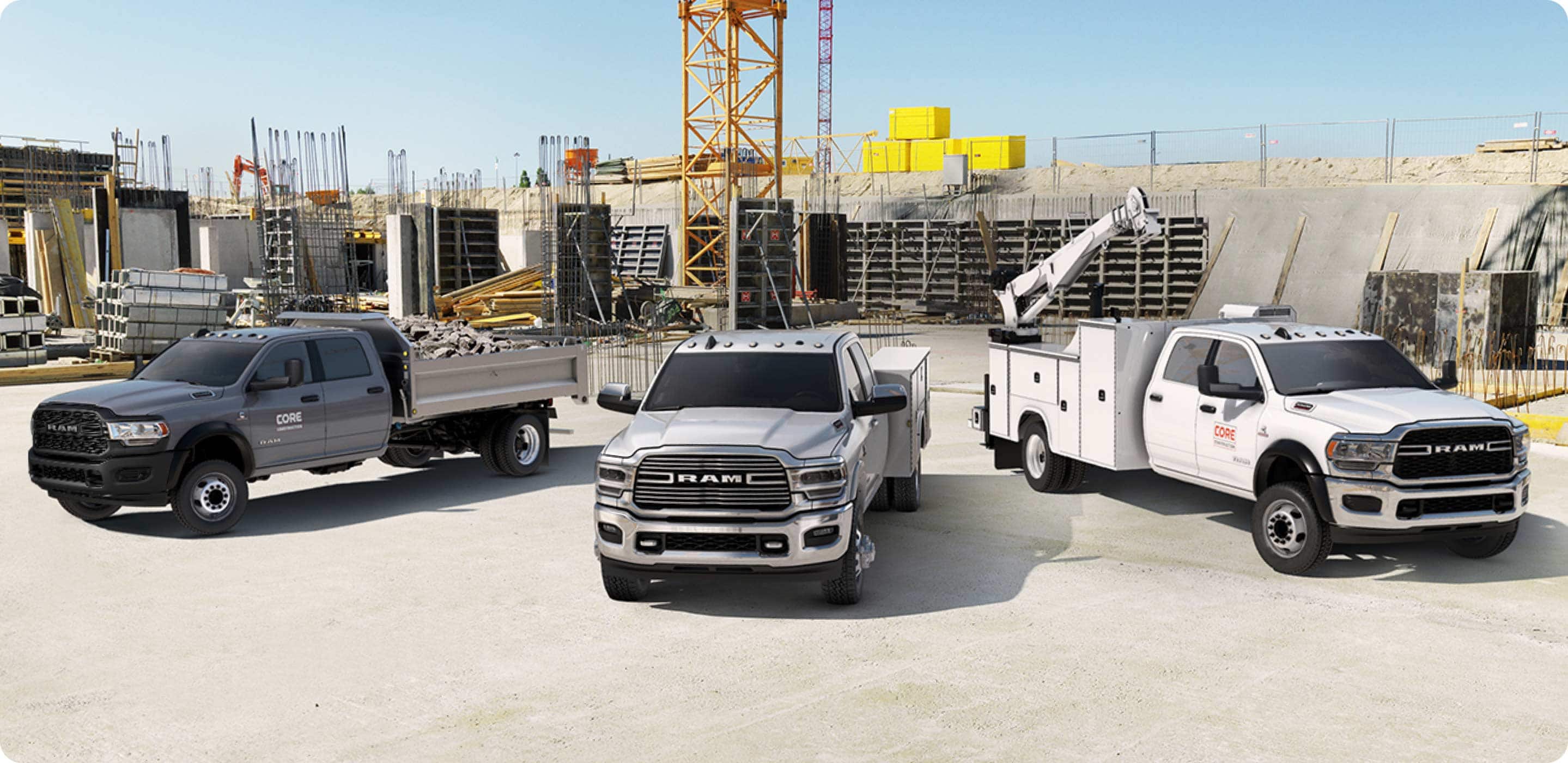 Display Three 2021 Ram Chassis Cab models on a construction site, each with a different upfit.