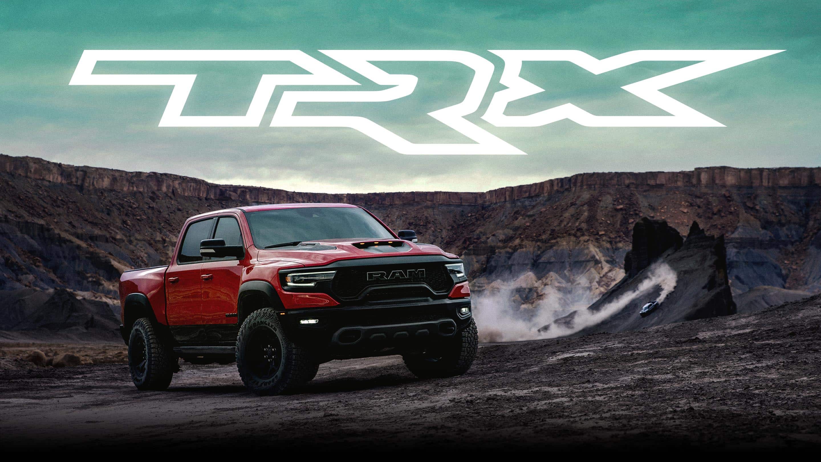 TRX logo. The 2021 Ram 1500 TRX parked on a rocky mesa.