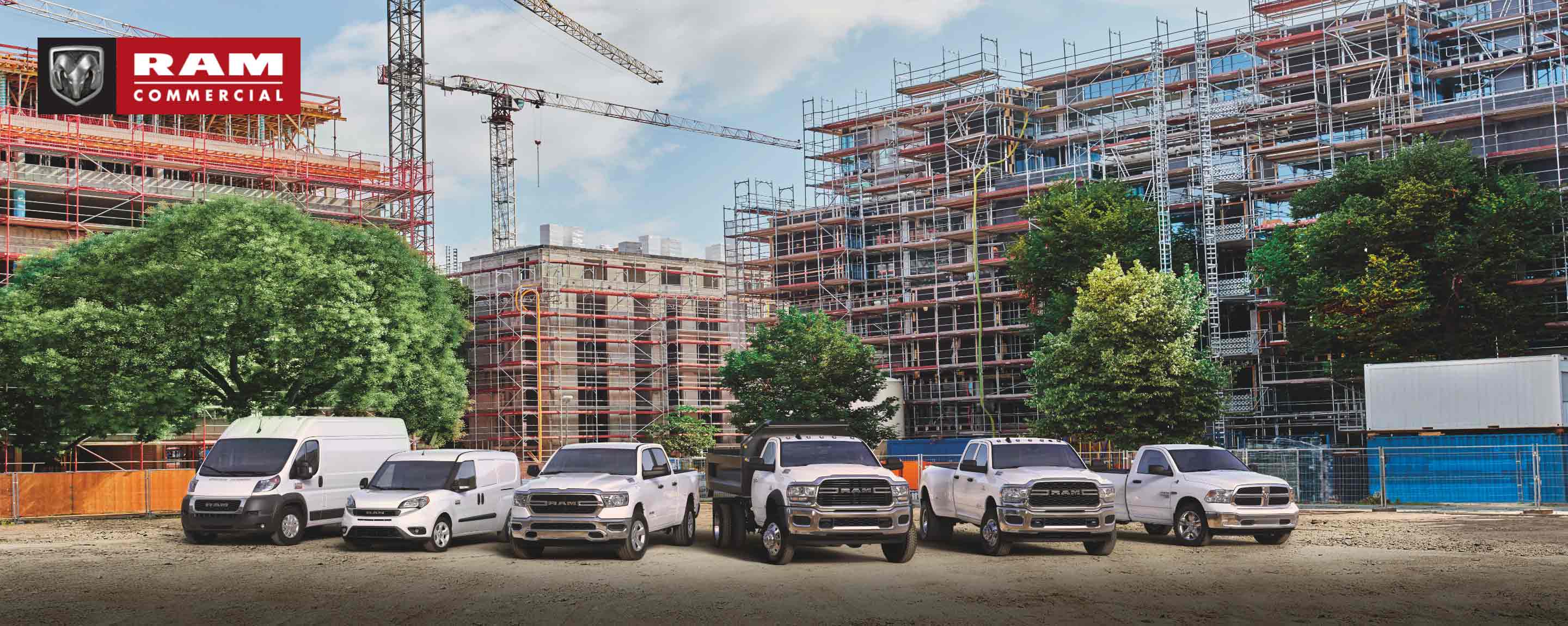 Ram Commercial. The 2022 Ram lineup parked at a massive commercial construction site. From left to right: a Ram ProMaster High Roof, Ram ProMaster City Cargo Van, Ram 1500, Ram 5500 Chassis Cab with dump body, Ram 3500 and Ram 1500 Classic.