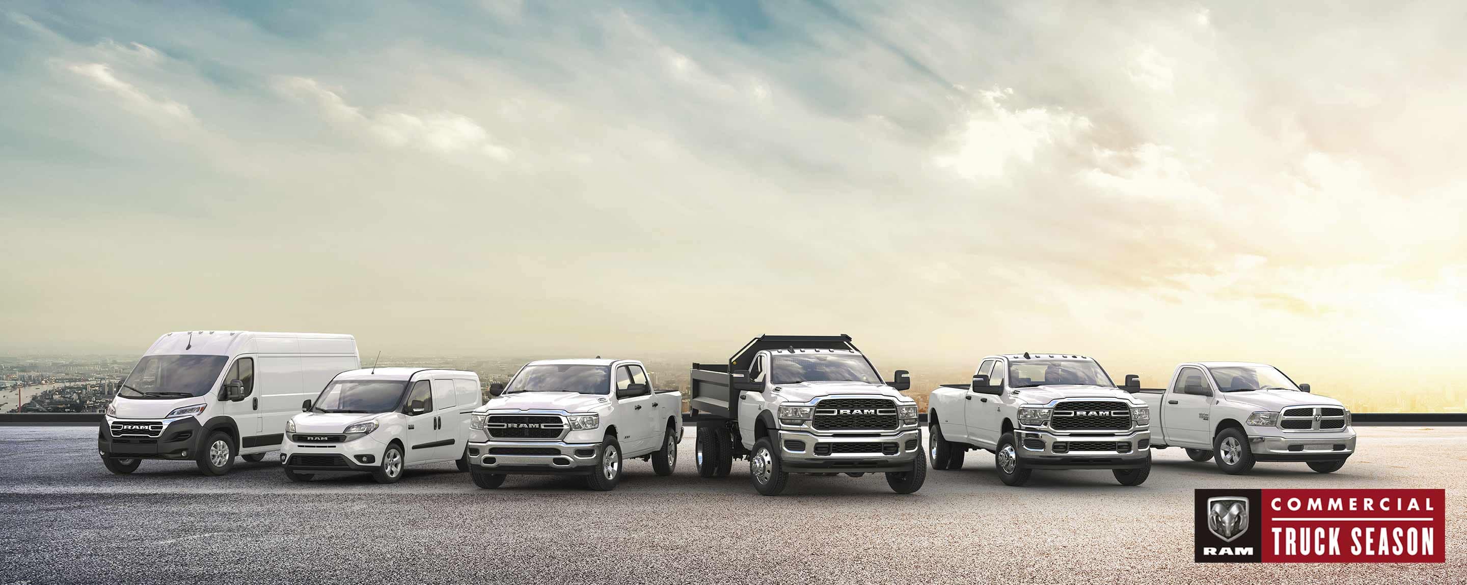 The Ram Brand lineup, all in white, parked side-by-side. Beginning on the left: a 2023 Ram ProMaster 3500 High Roof Cargo Van, 2022 Ram ProMaster City Cargo Van, 2023 Ram 1500 Tradesman Crew Cab, 2023 Ram 5500 Tradesman Regular Cab with dump body, 2023 Ram 3500 Tradesman Crew Cab and 2023 Ram 1500 Classic Regular Cab. Ram Commercial Truck Season.
