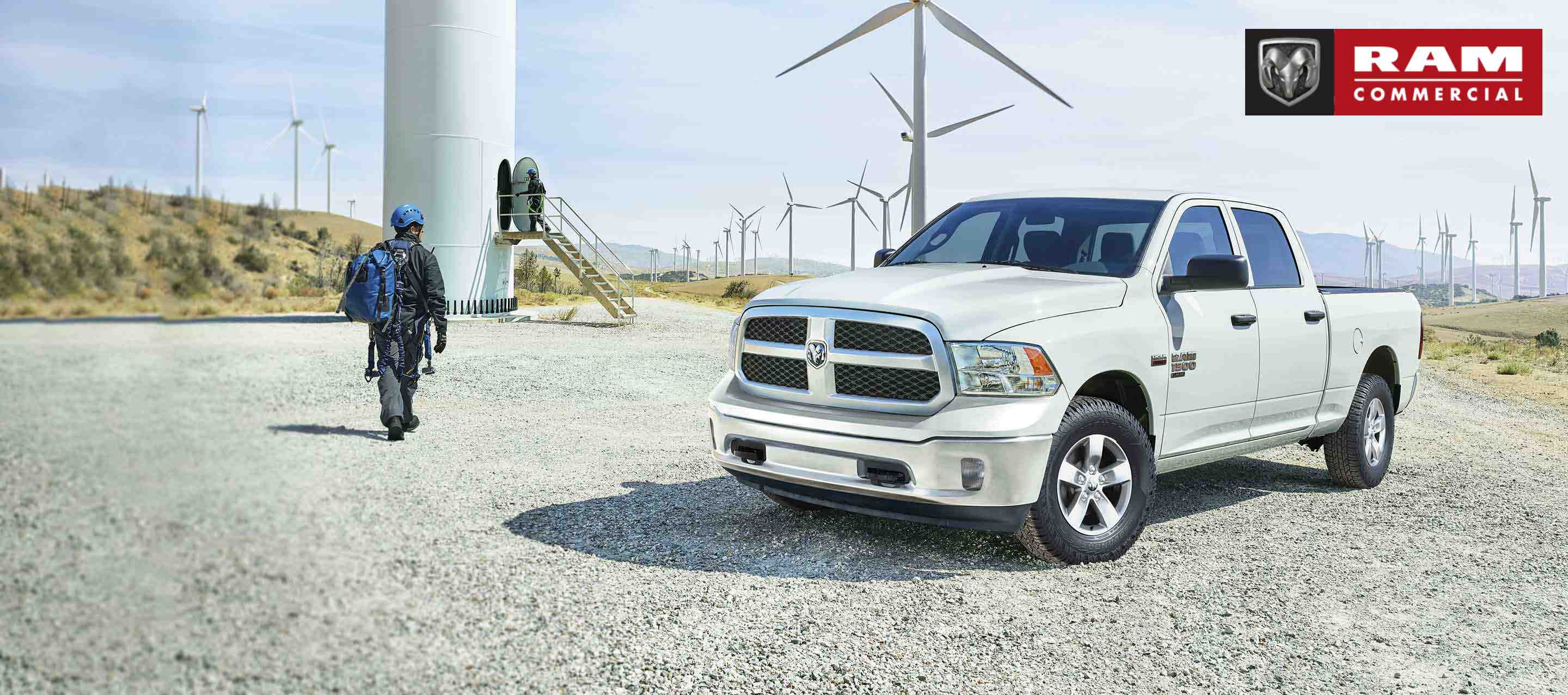 A 2022 Ram 1500 Classic Tradesman 4x4 Crew Cab parked on a wind farm. Ram Commercial Truck Season. Ram Commercial.