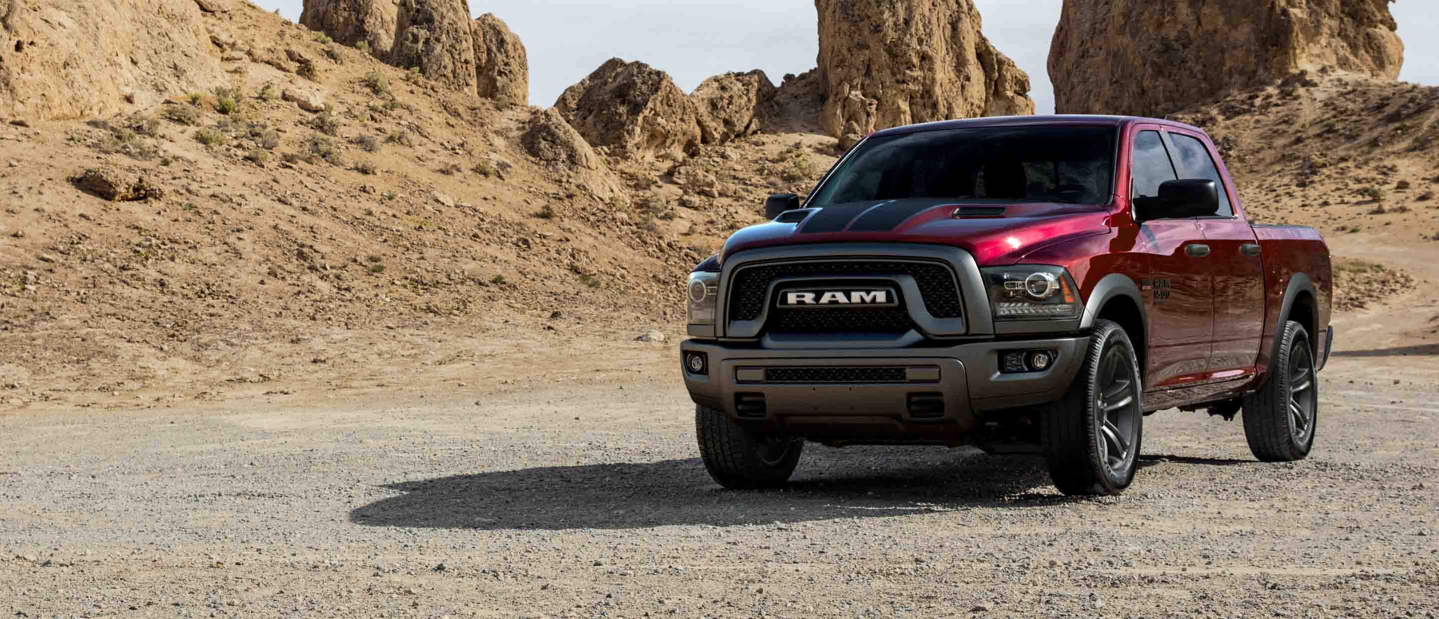 The 2022 Ram 1500 Classic parked on a twisting desert road with rocky outcroppings in the distance.