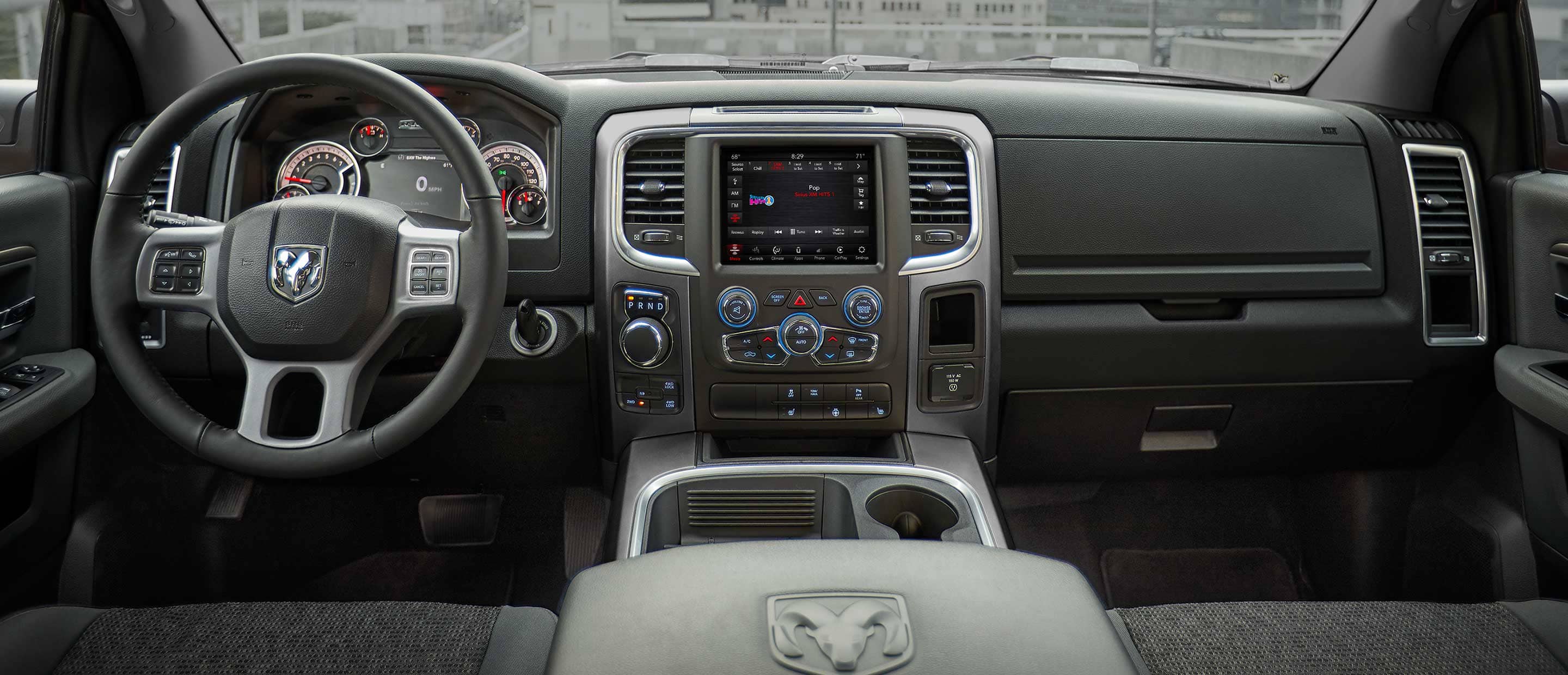 The interior of the 2022 Ram 1500 Classic, focusing on the steering wheel, Uconnect touchscreen and dashboard.