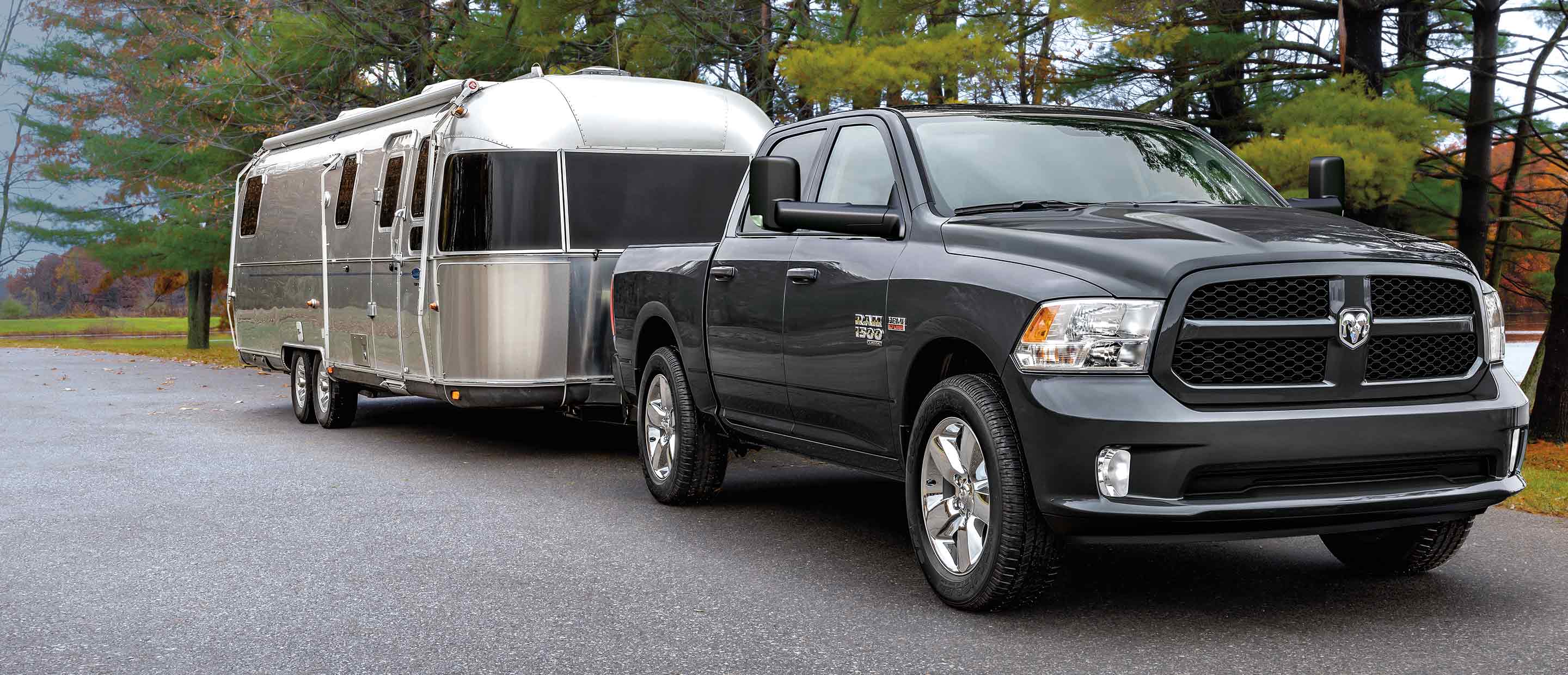 The 2022 Ram 1500 Classic towing a camper trailer.