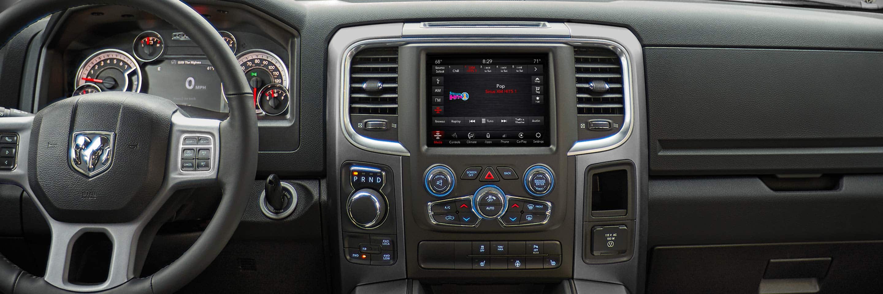 The interior of the 2022 Ram 1500 Classic showing the steering wheel, dashboard and entertainment center.