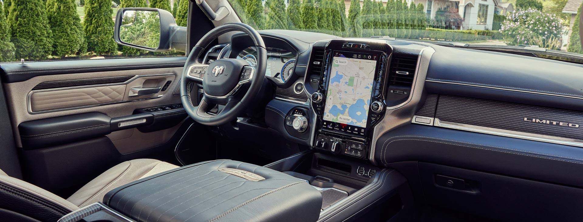 The interior of the 2022 Ram 1500 Limited 10th Anniversary Edition with the available 12-inch Uconnect touchscreen displaying a route map.
