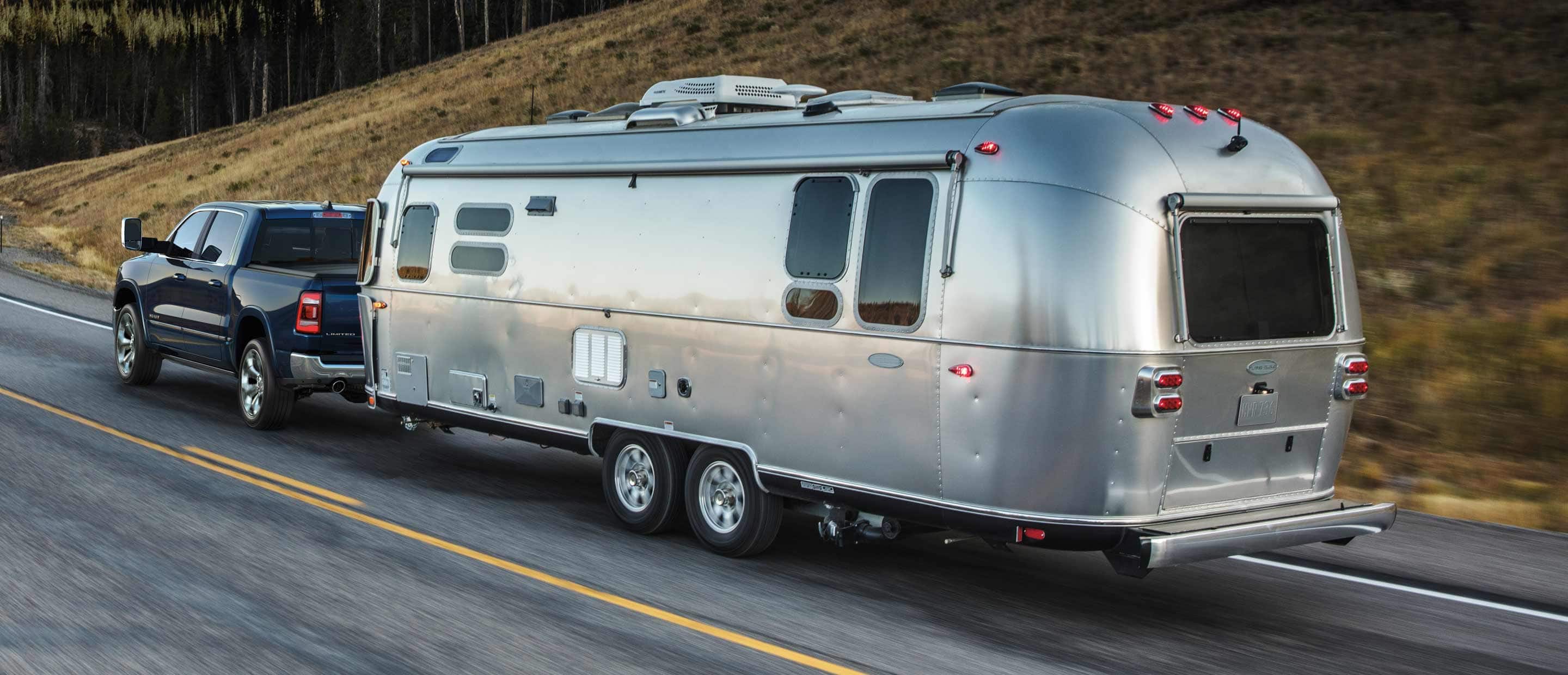 The 2022 Ram 1500 towing a large streamlined trailer.