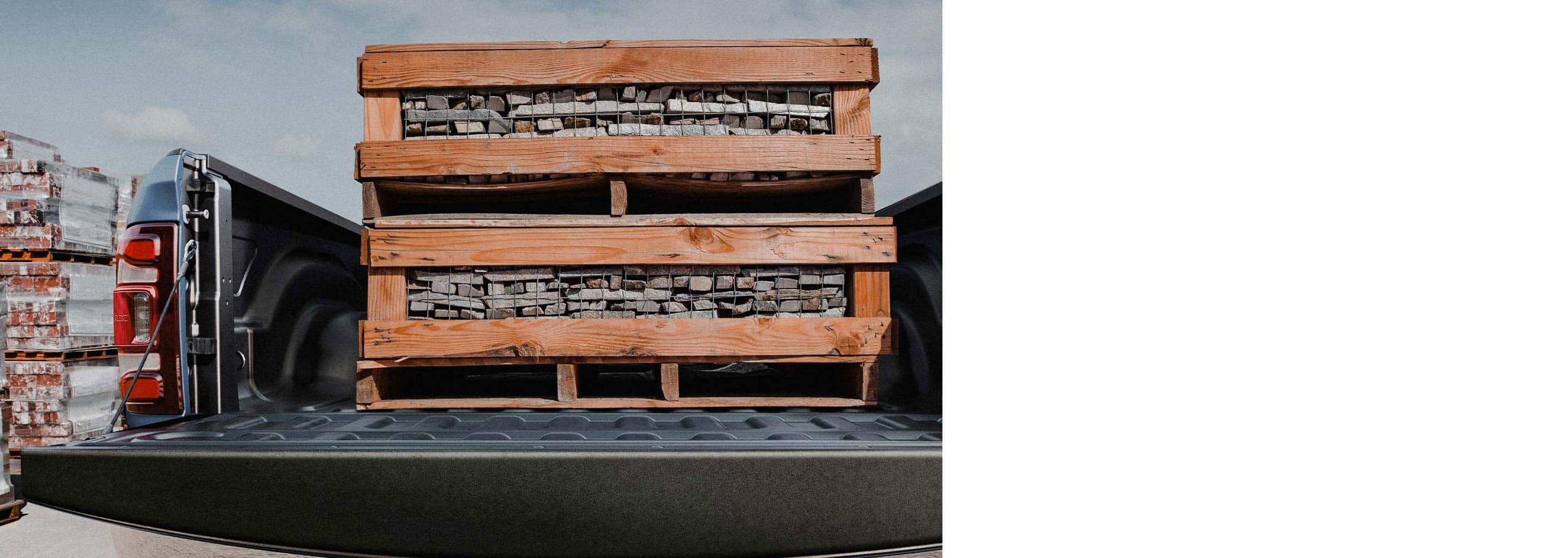 The bed of the 2022 Ram 2500 stacked with two pallets of paving stones.