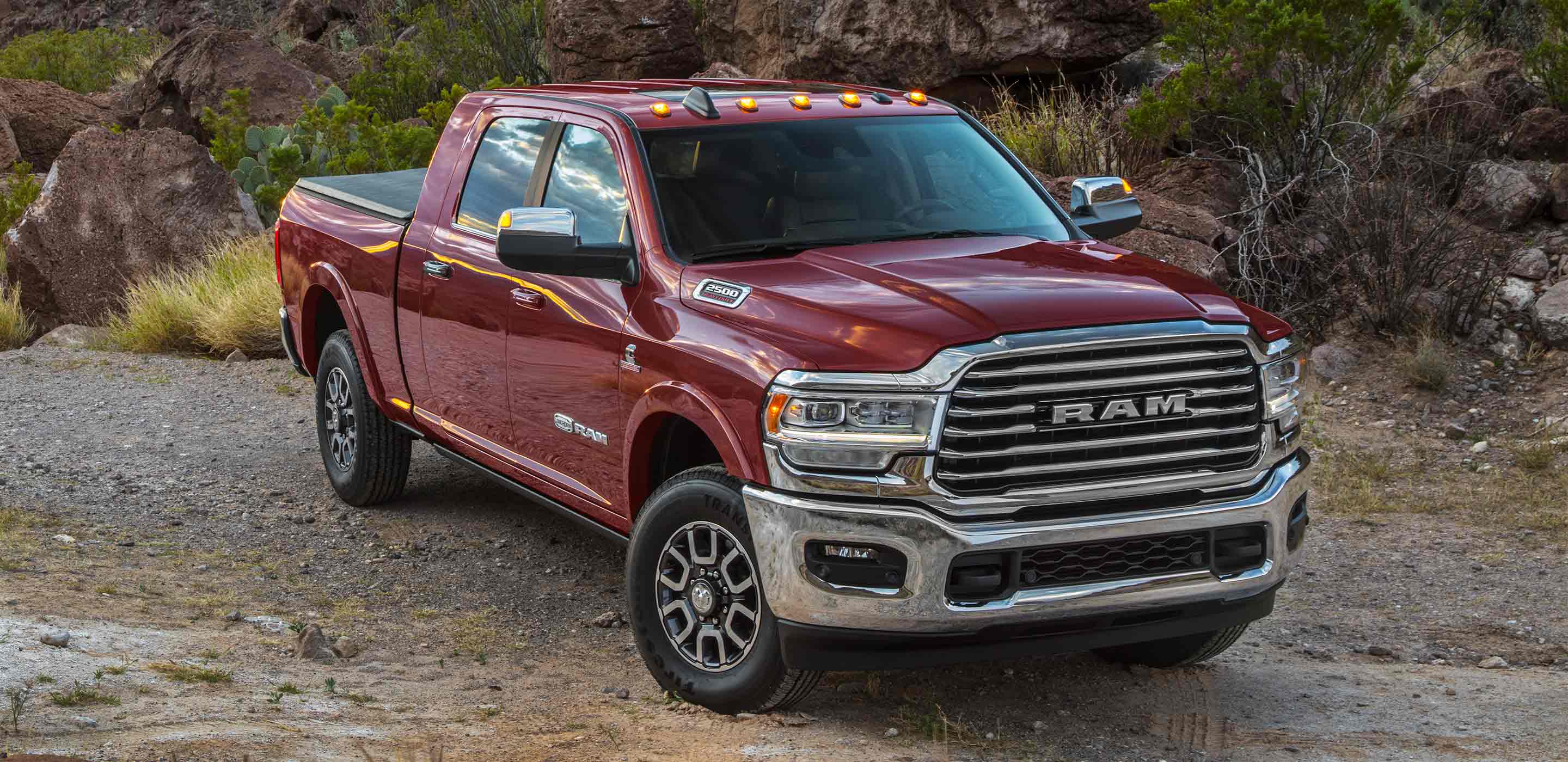 Display The 2022 Ram 2500 being driven on a gravel road.