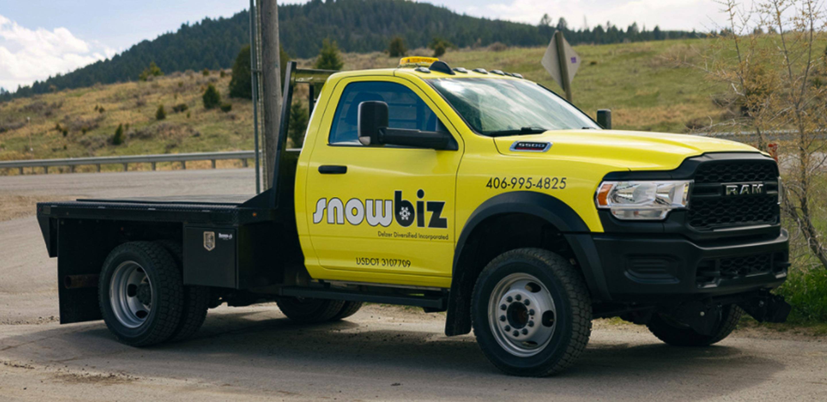 Display A 2022 Ram Chassis Cab with a snow removal logo on its side.