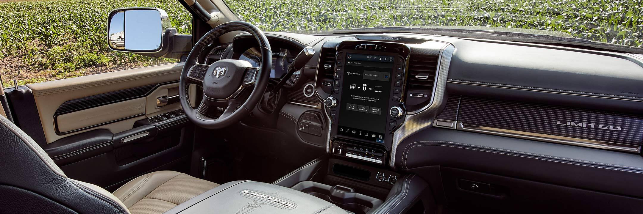 The interior of the 2022 Ram Chassis Cab with a view through the windows of green fields surrounding it.