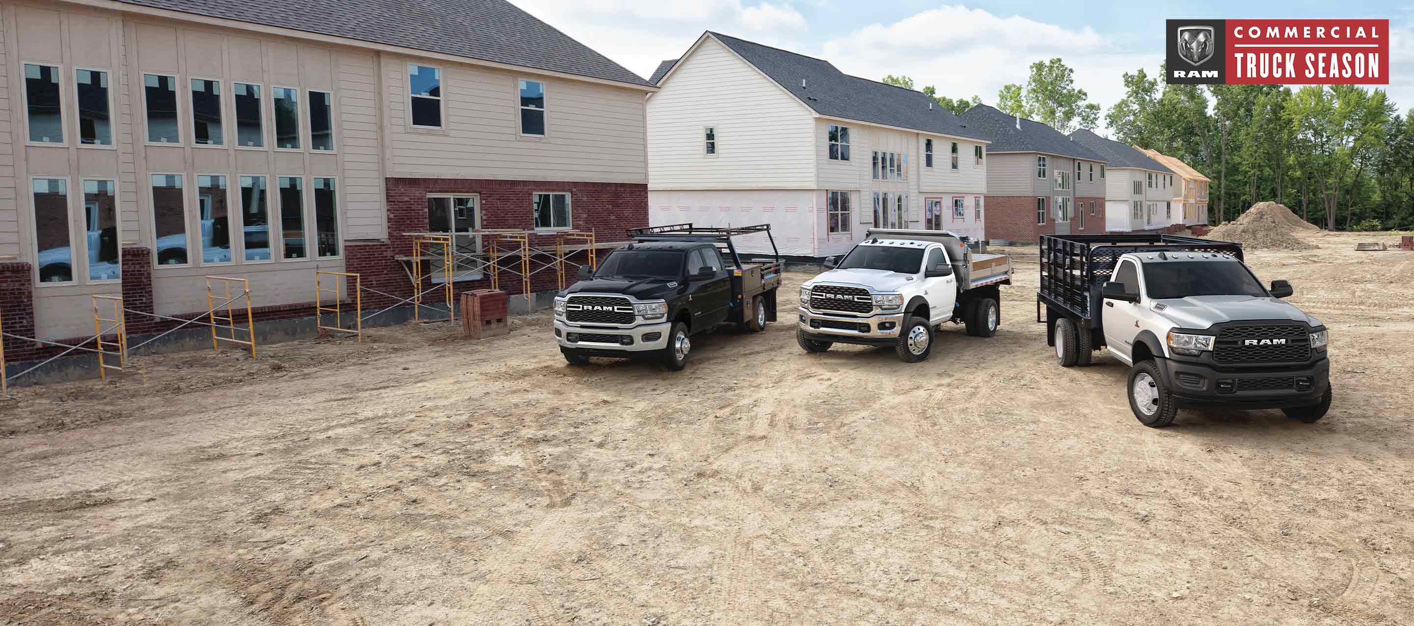 The 2022 Ram 3500 Tradesman 4x4 with Crew Cab; the 2022 Ram 5500 SLT 4x4 with Regular Cab and the 2022 Ram 4500 Tradesman 4x4 with Regular Cab parked on a construction site. Ram Commercial Truck season.