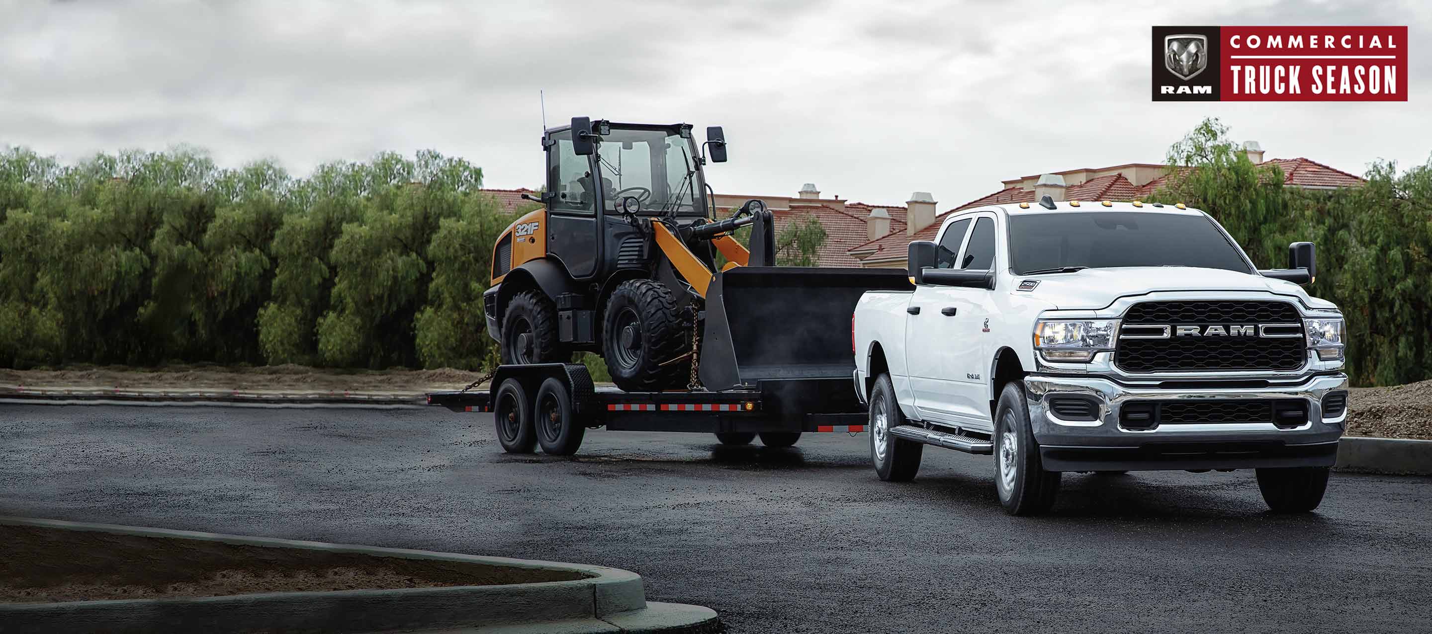 A 2022 Ram 2500 Laramie 4x4 with a stainless steel v-plow upfit, clearing away snow on a mountain road. Ram Commercial.
