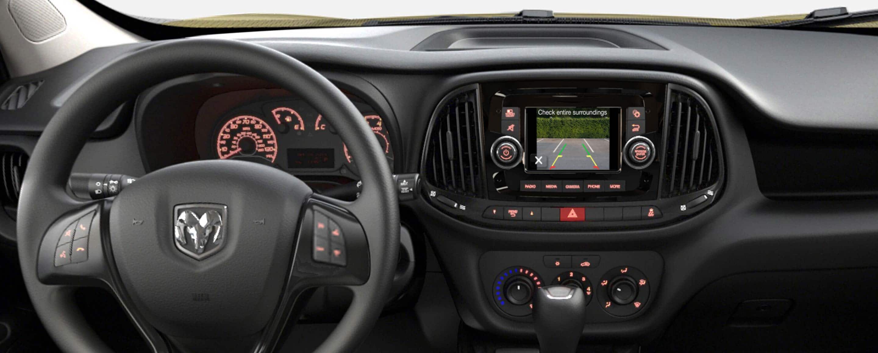 The touchscreen in the 2022 Ram ProMaster City, displaying the area behind the vehicle with overlaid guidelines showing the vehicle's path.