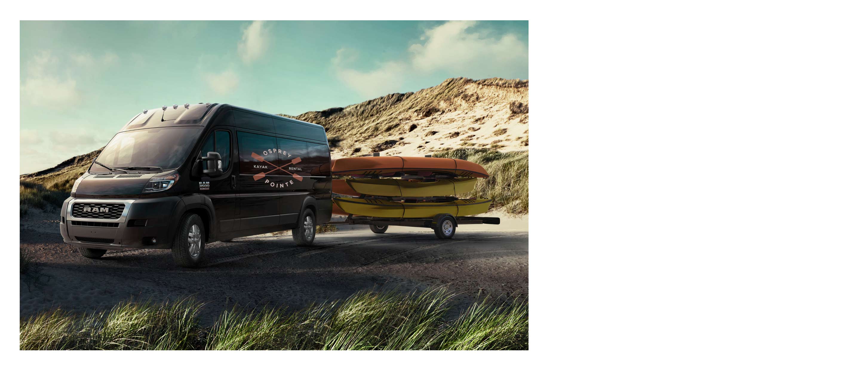 The 2022 Ram ProMaster towing a flatbed loaded with five kayaks.