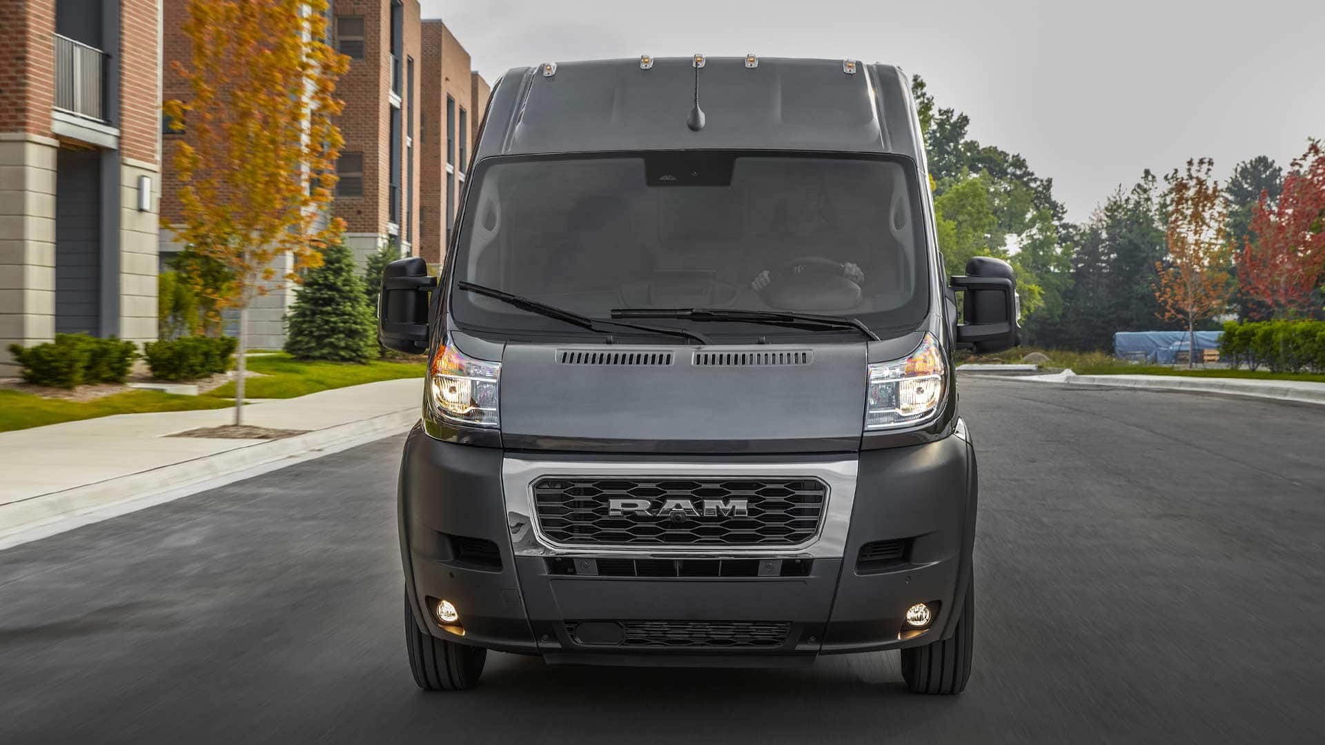 Display The 2022 Ram ProMaster being driven on a residential street.