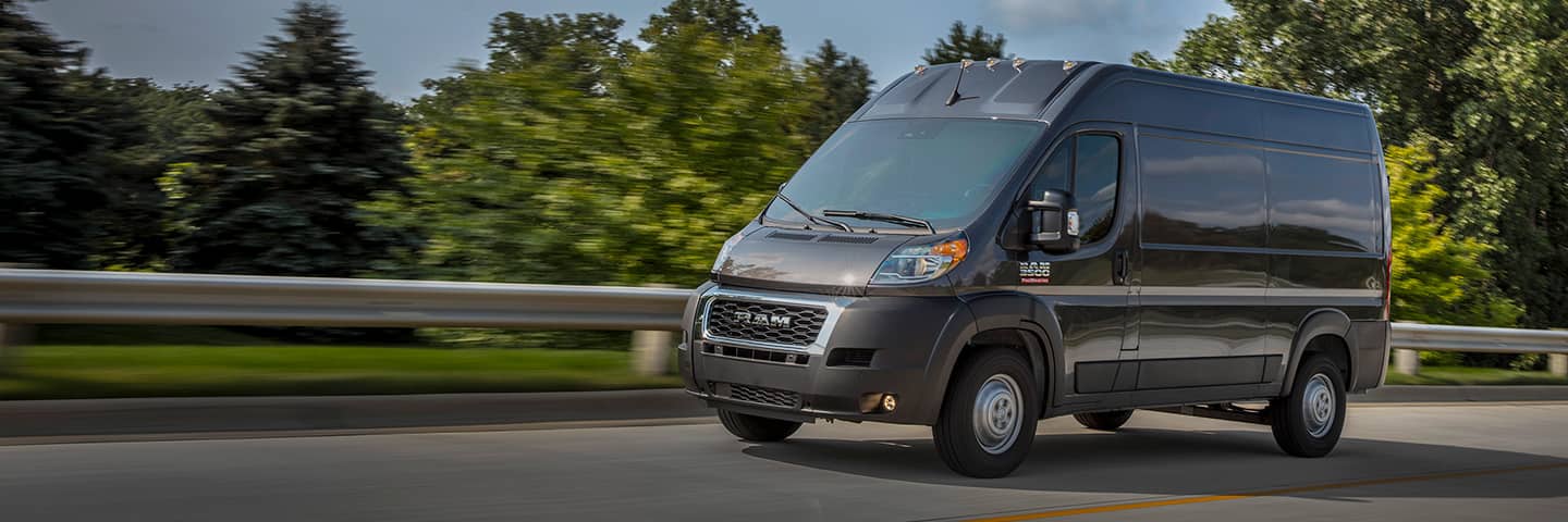 The 2022 Ram ProMaster being driven past a park.