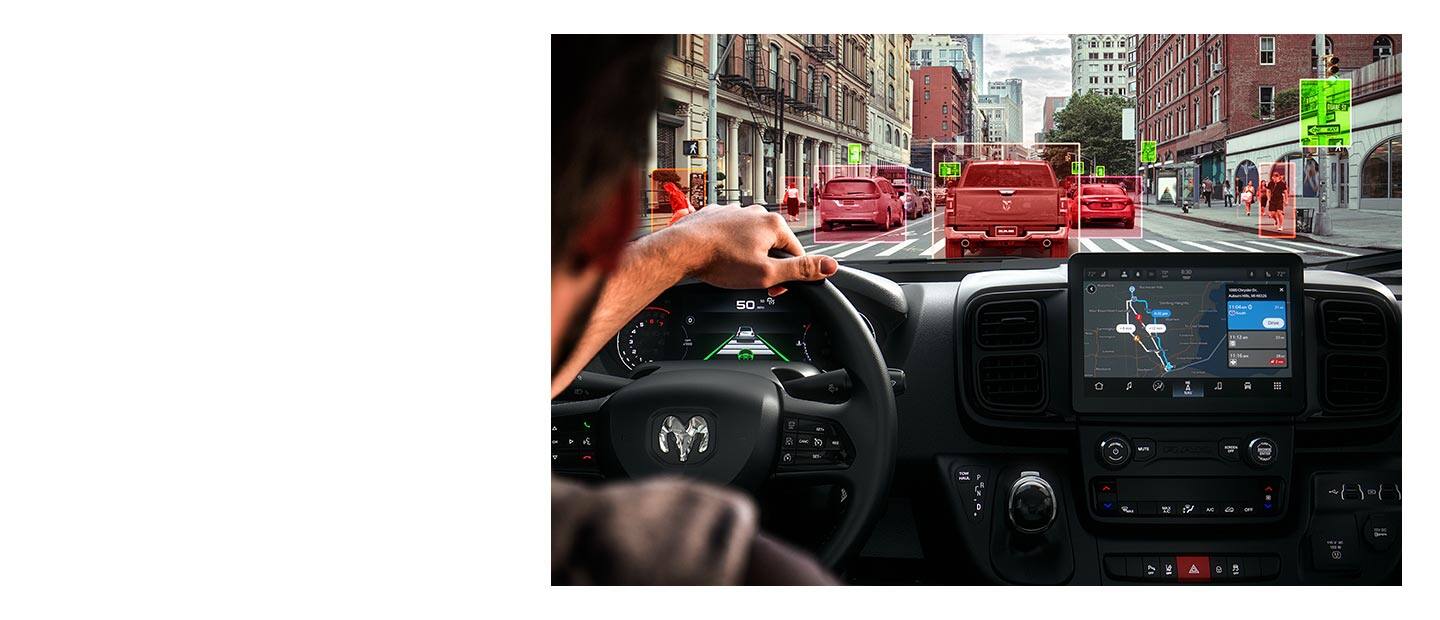 The view through a windshield of a 2022 Ram ProMaster with traffic signs highlighted in green and vehicles and pedestrians highlighted in red.