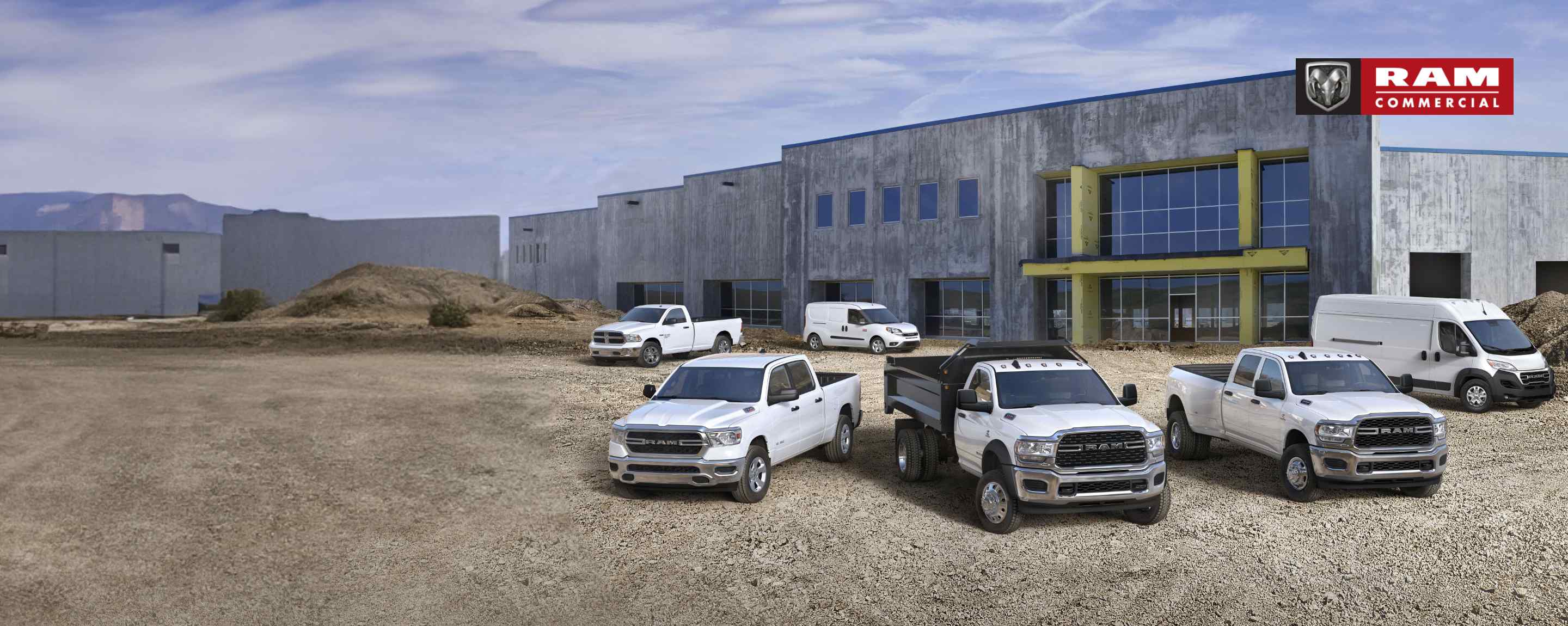 A lineup of six Ram trucks and vans on a construction site. Ram Commercial.
