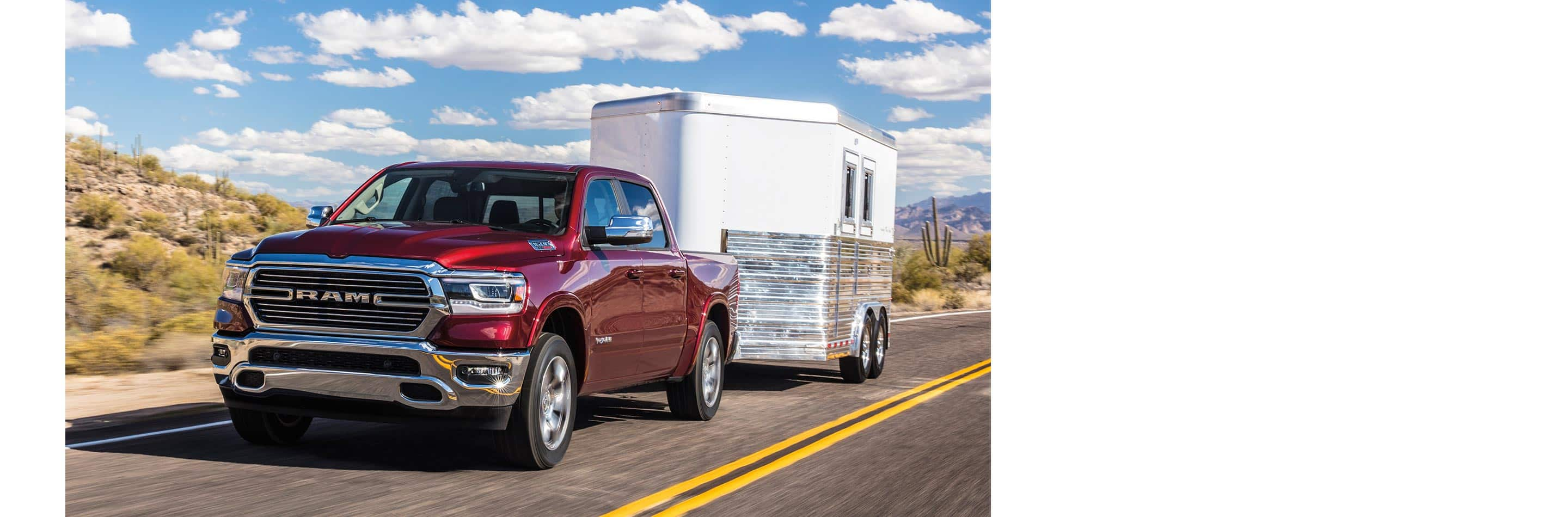 The 2023 Ram 1500 towing an enclosed trailer.