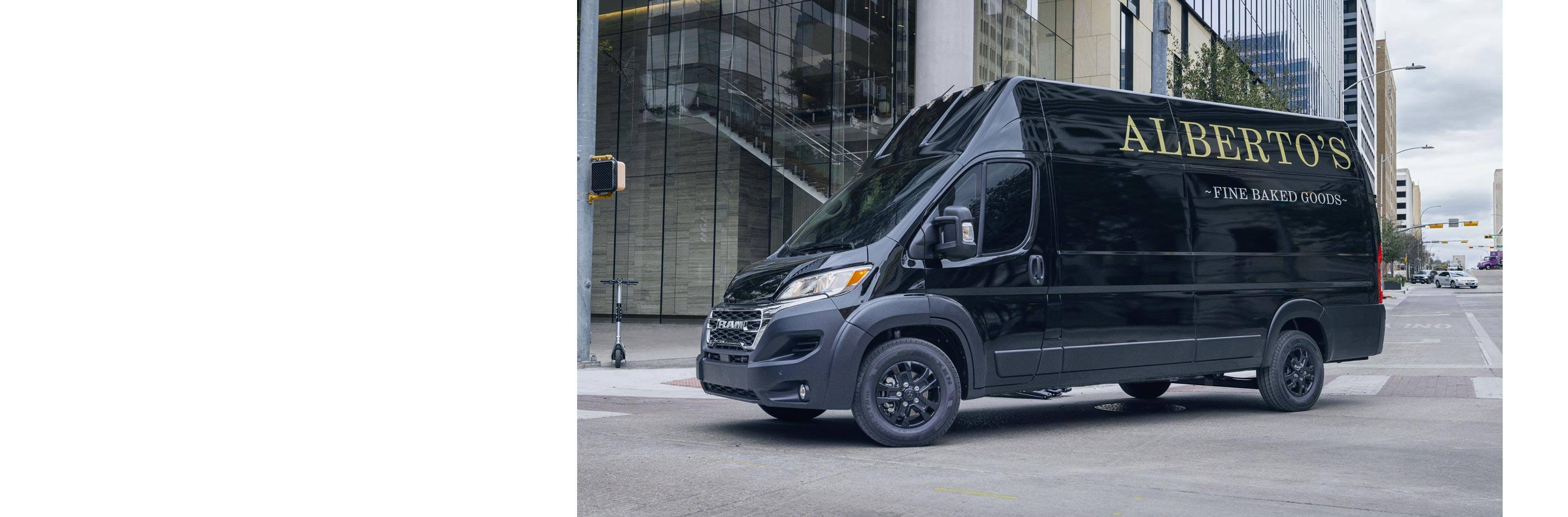 A 2023 Ram ProMaster with the logo for a bakery on its side turning a corner on a busy street.