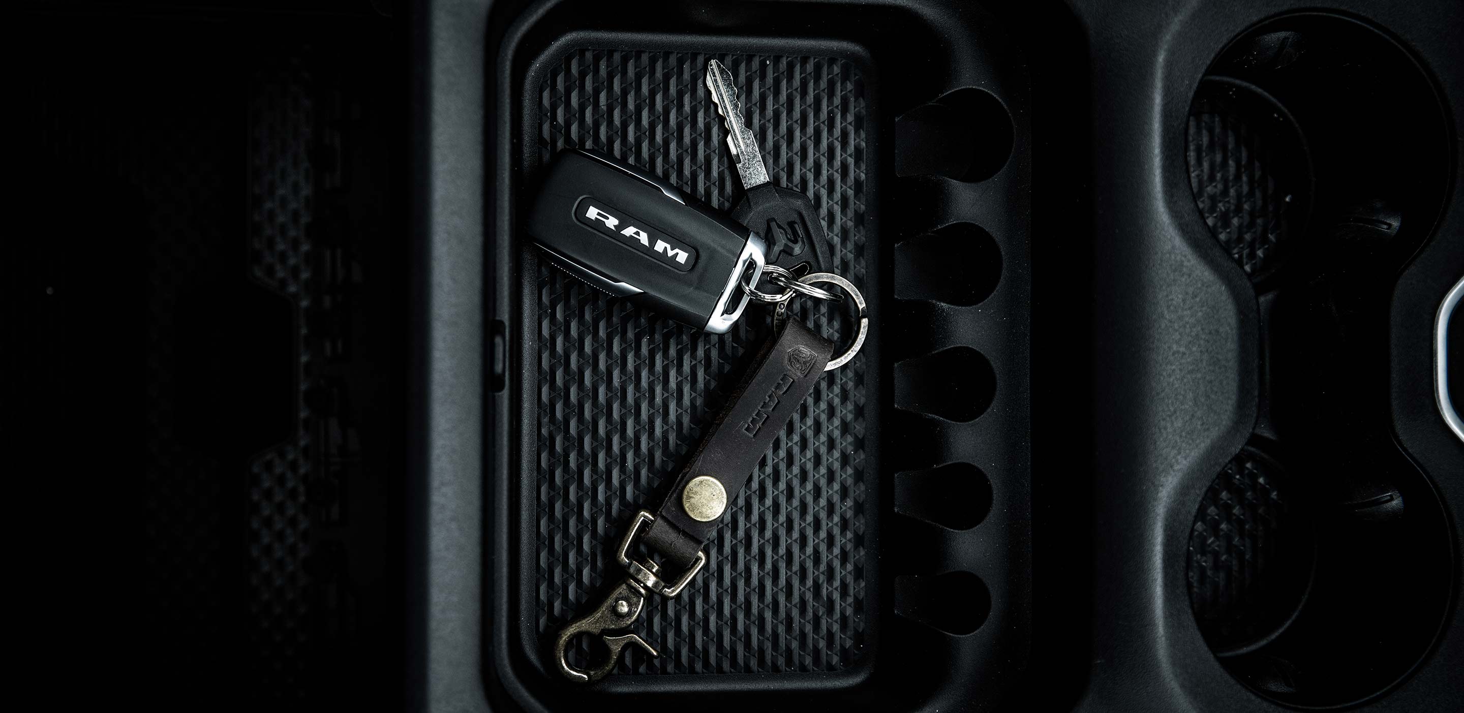 2024 Ram Truck keys sitting in cupholder center console.