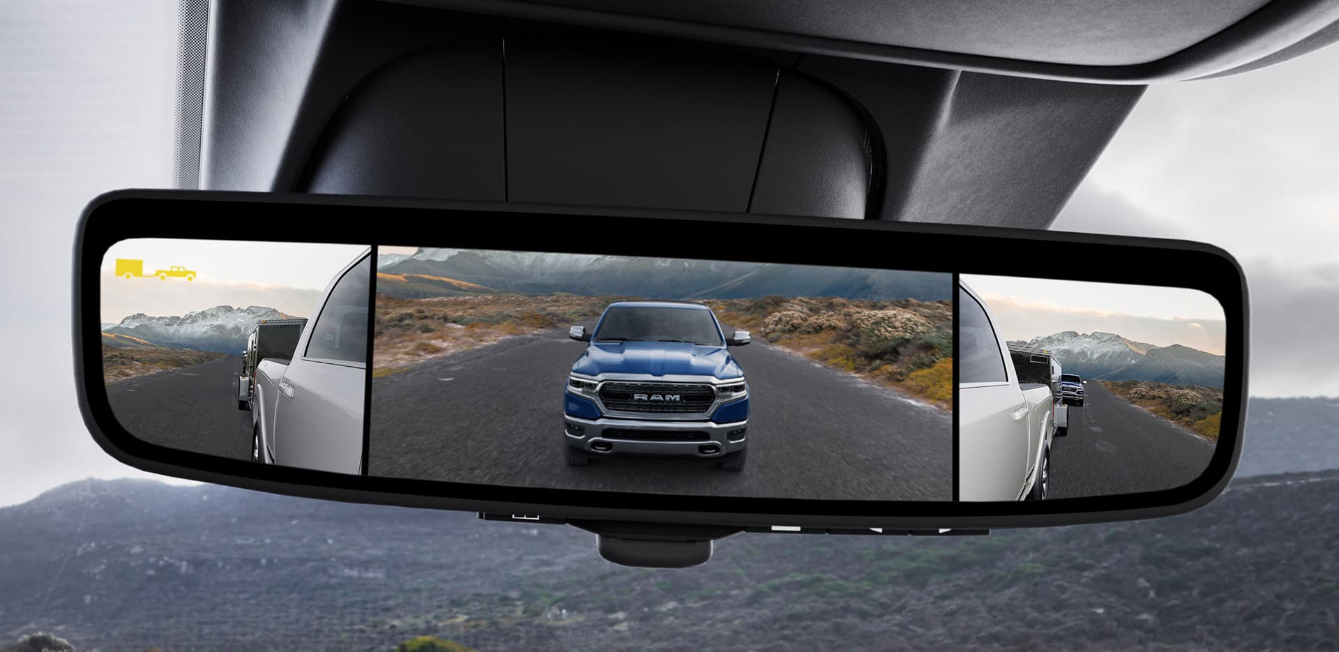 A close-up of the Digital Rearview Mirror in the 2023 Ram 2500 displaying the output of the rear-facing camera in tow mode and the two exterior trailer-tow mirror cameras.