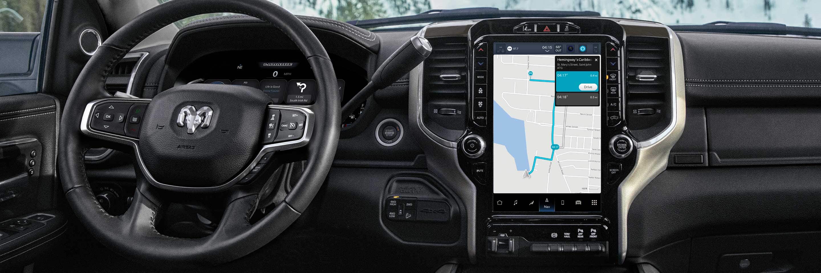 The steering wheel and Uconnect touchscreen in the 2023 Ram 3500 Laramie, with the screen displaying a navigation map.
