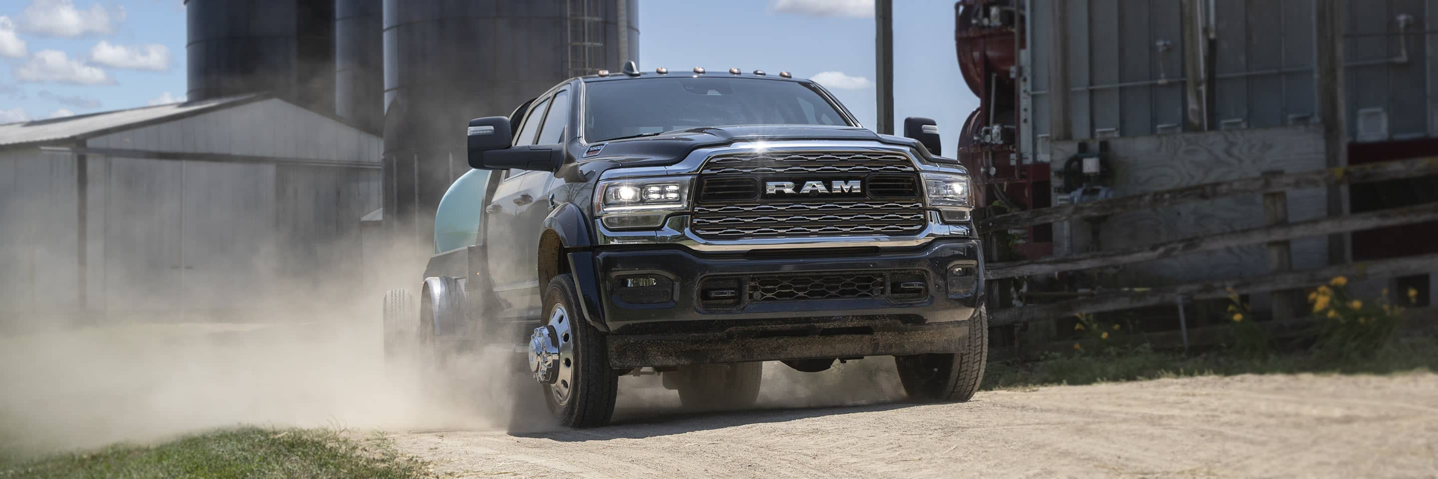 A 2023 Ram Chassis Cab carrying an irrigation tank, at a commercial farm.