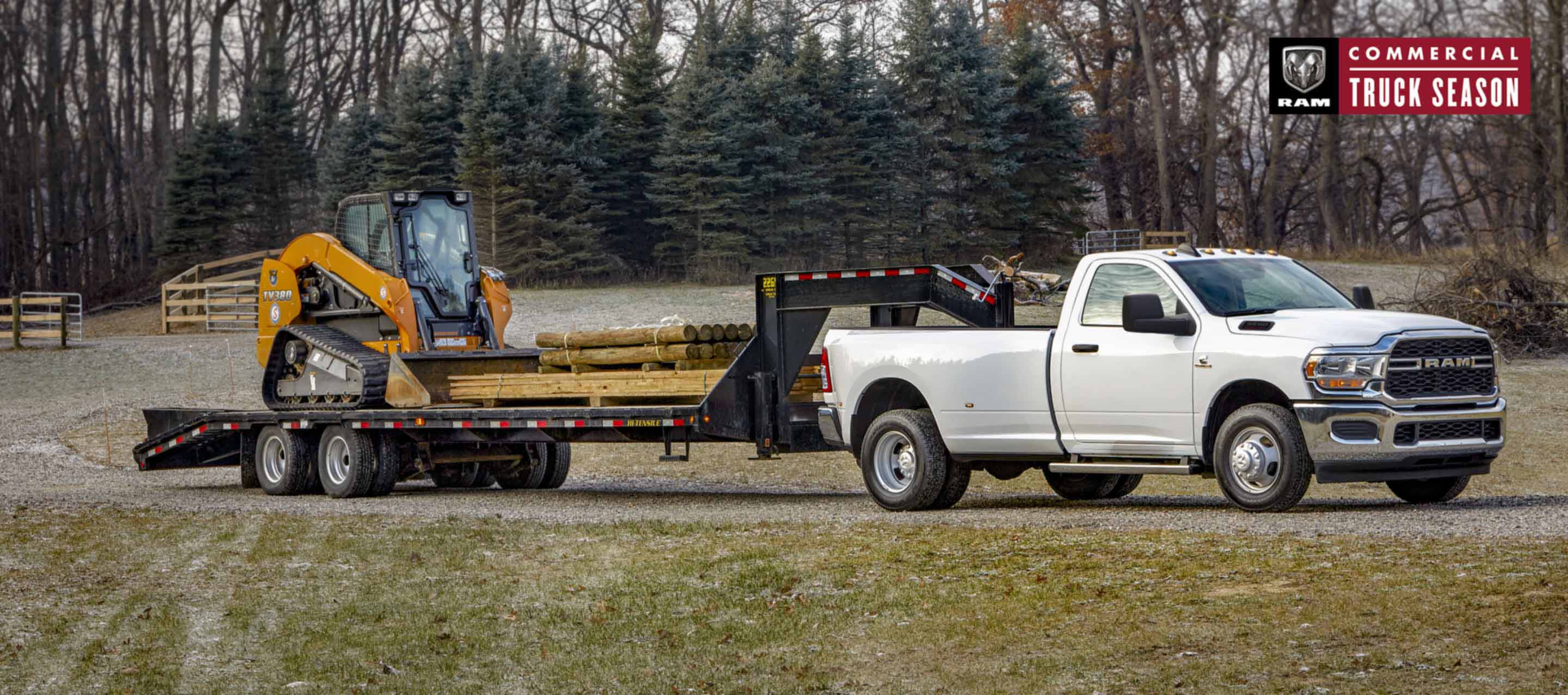 A white 2023 Ram 3500 Tradesman 4x4 Regular Cab towing a fifth wheel flatbed trailer loaded with lumber. Ram Commercial Truck Season. 