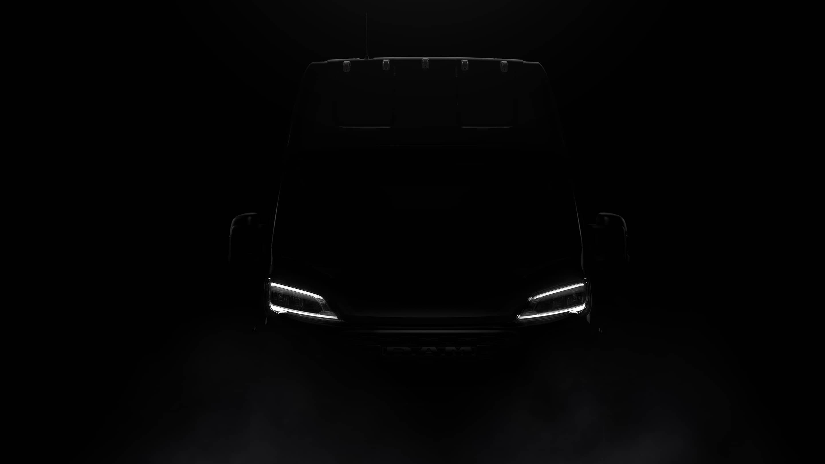 Display A silhouette of the 2023 Ram ProMaster 3500 Cargo Van Super High Roof in a darkened room, with the sole illumination coming from its lit headlamps.
