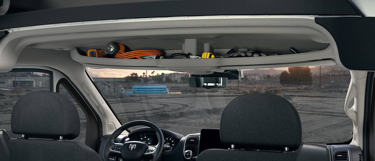 The headliner in the 2023 Ram ProMaster with small items stored in it: gloves, a mesasuring tape, a coil of wire and more.