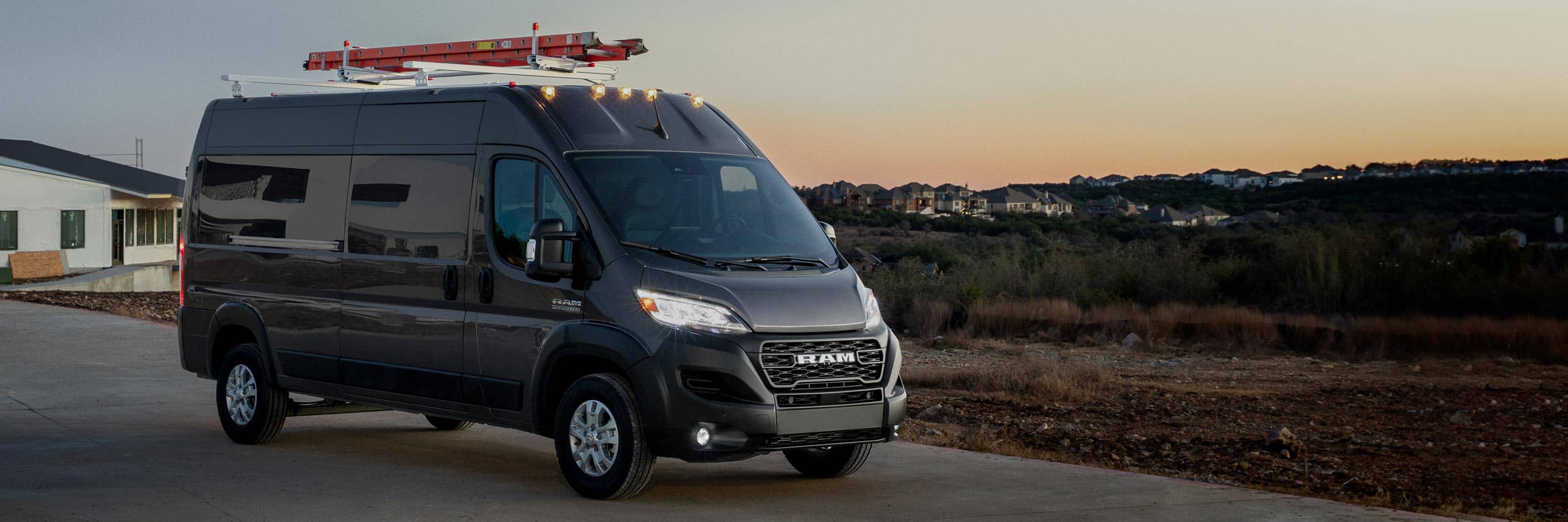 The 2023 Ram ProMaster 2500 Cargo Van with a ladder on its roof rack.