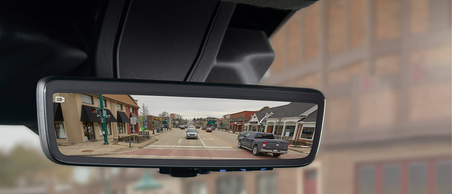 A close-up of the digital rearview mirror in the 2023 Ram ProMaster with a camera icon in the corner of the mirror to indicate that the camera feed is on.