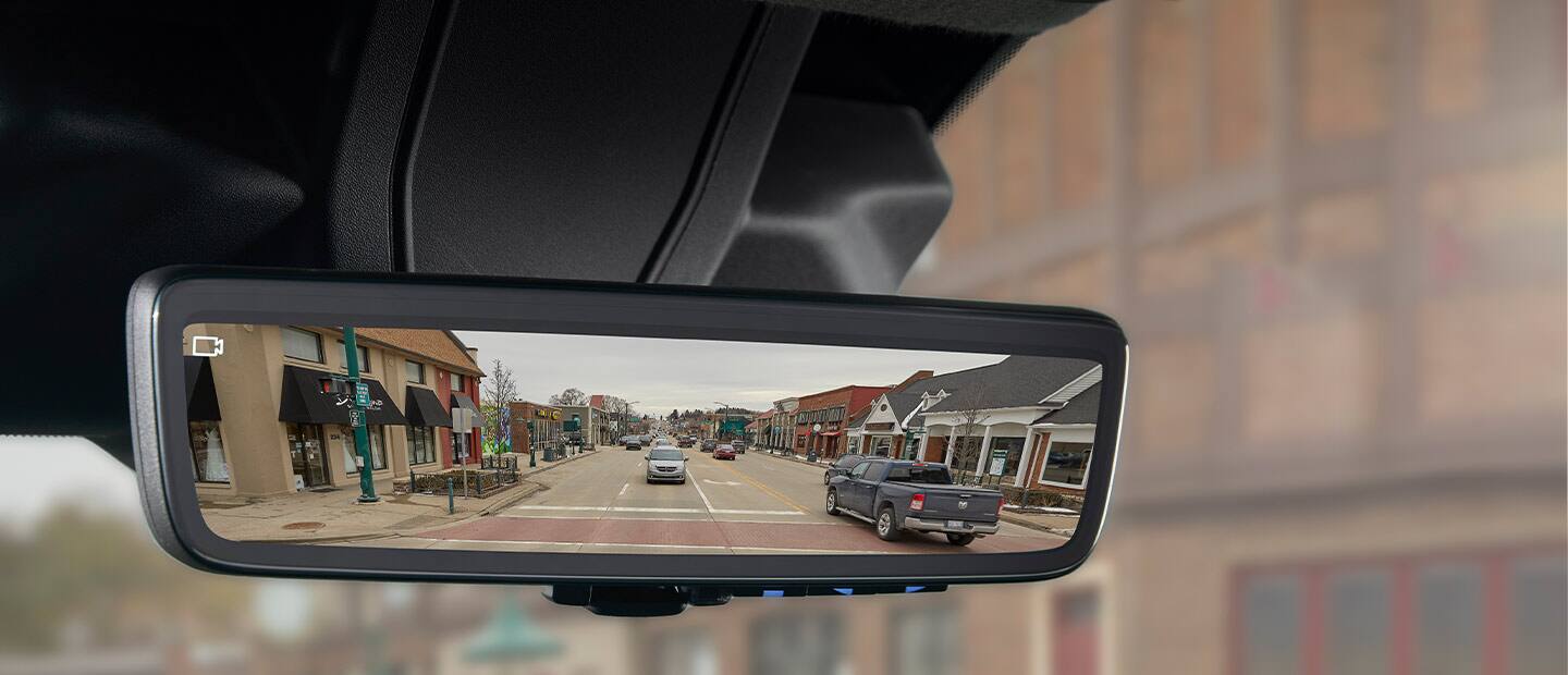 A close-up of the digital rearview mirror in the 2023 Ram ProMaster with a camera icon in the corner of the mirror to indicate that the camera feed is on.