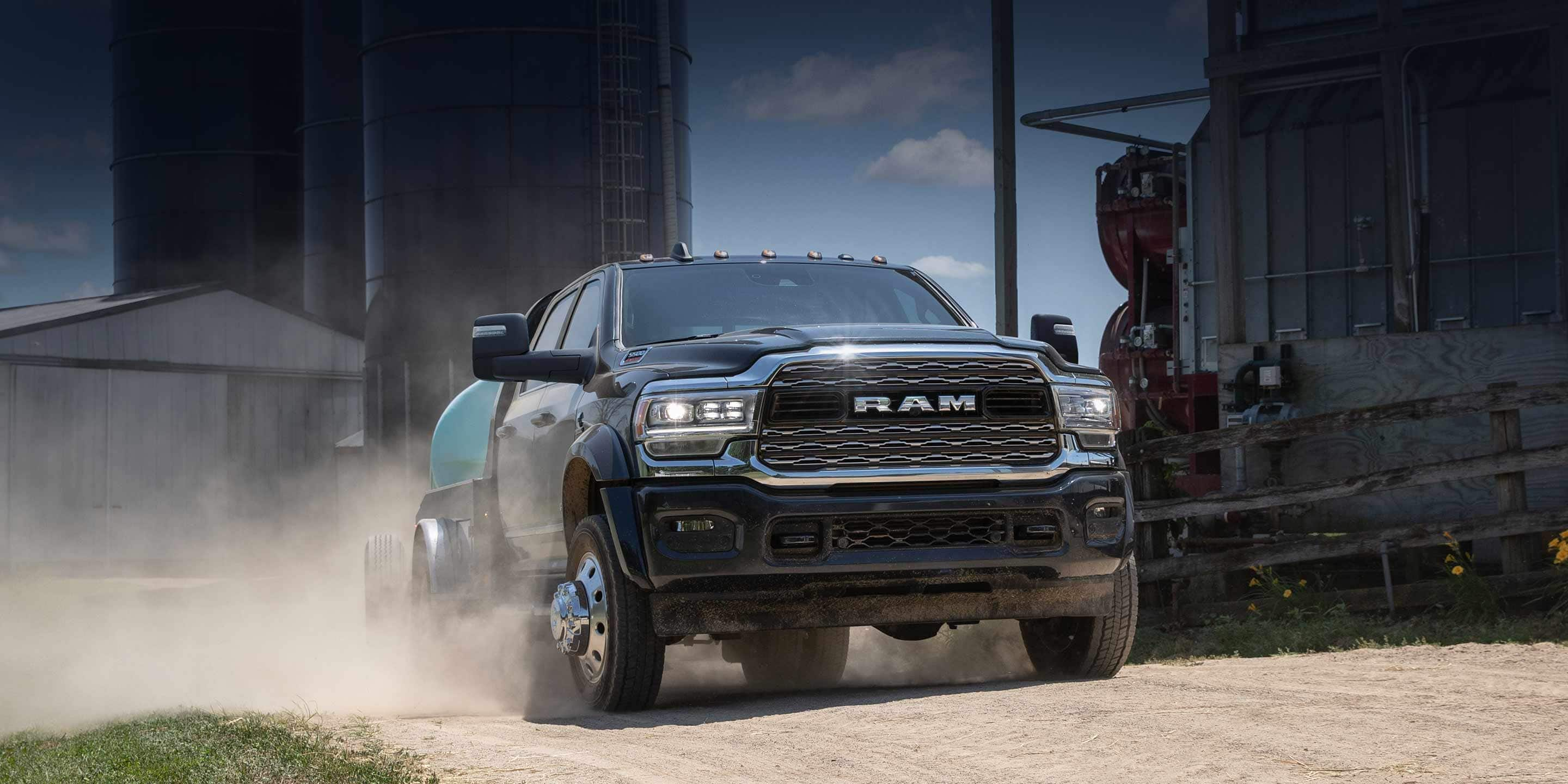 A 2024 Ram 5500 Limited Chassis Crew Cab towing an irrigation tank, at a commercial farm.