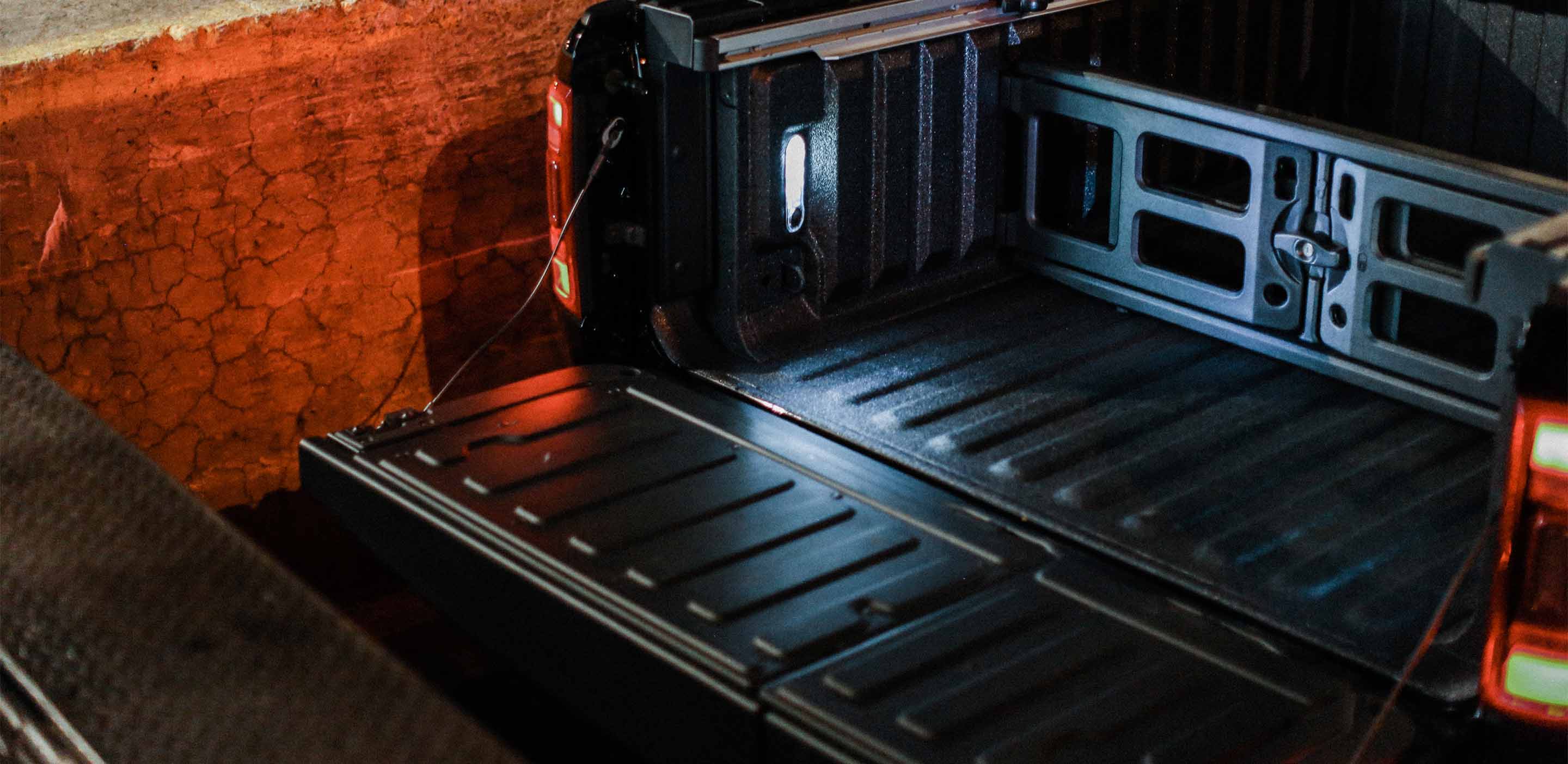 Display A close-up of the bed on the 2024 Ram 1500 with the tailgate lowered and a bed divider installed.