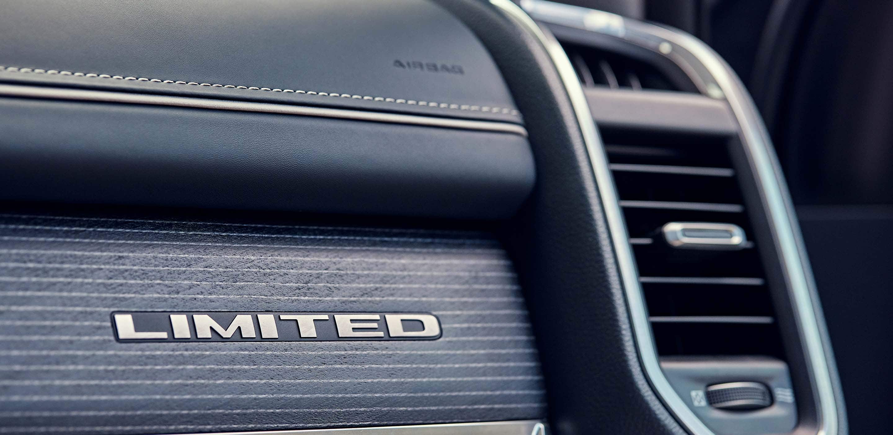 Display A close-up of the Limited badging on the passenger dashboard in the 2024 Ram 1500 Limited.