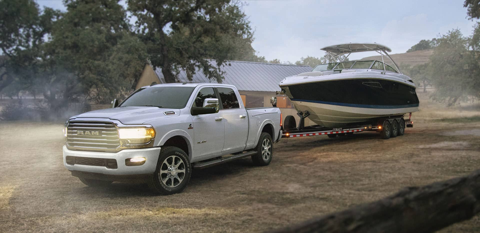 White RAM 2500 towing a motor boat at a campground