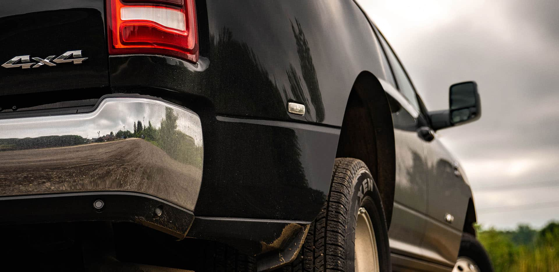 Display A close-up of the 4x4 badge on the rear bumper of a black 2024 Ram 3500 Laramie Crew Cab.