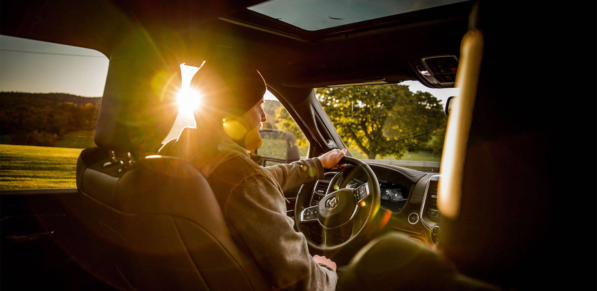 A man sitting in the drives seat of a truck.