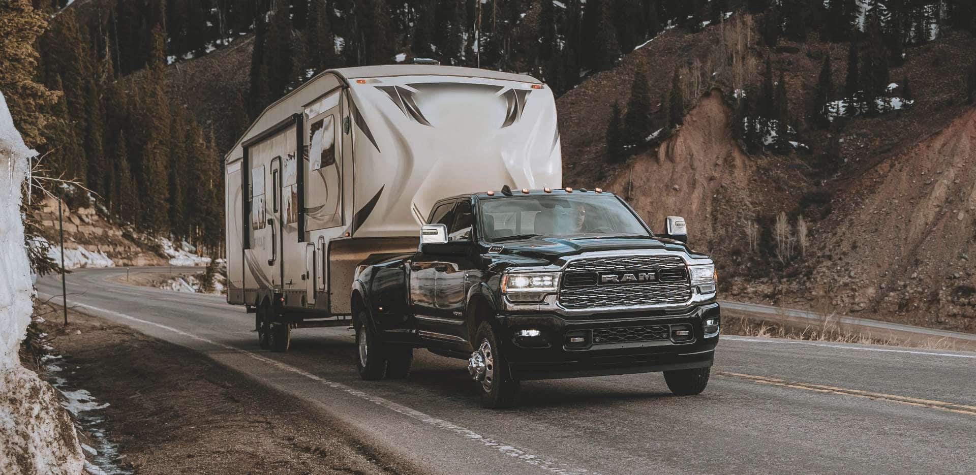 A ram pulling a mobile home.