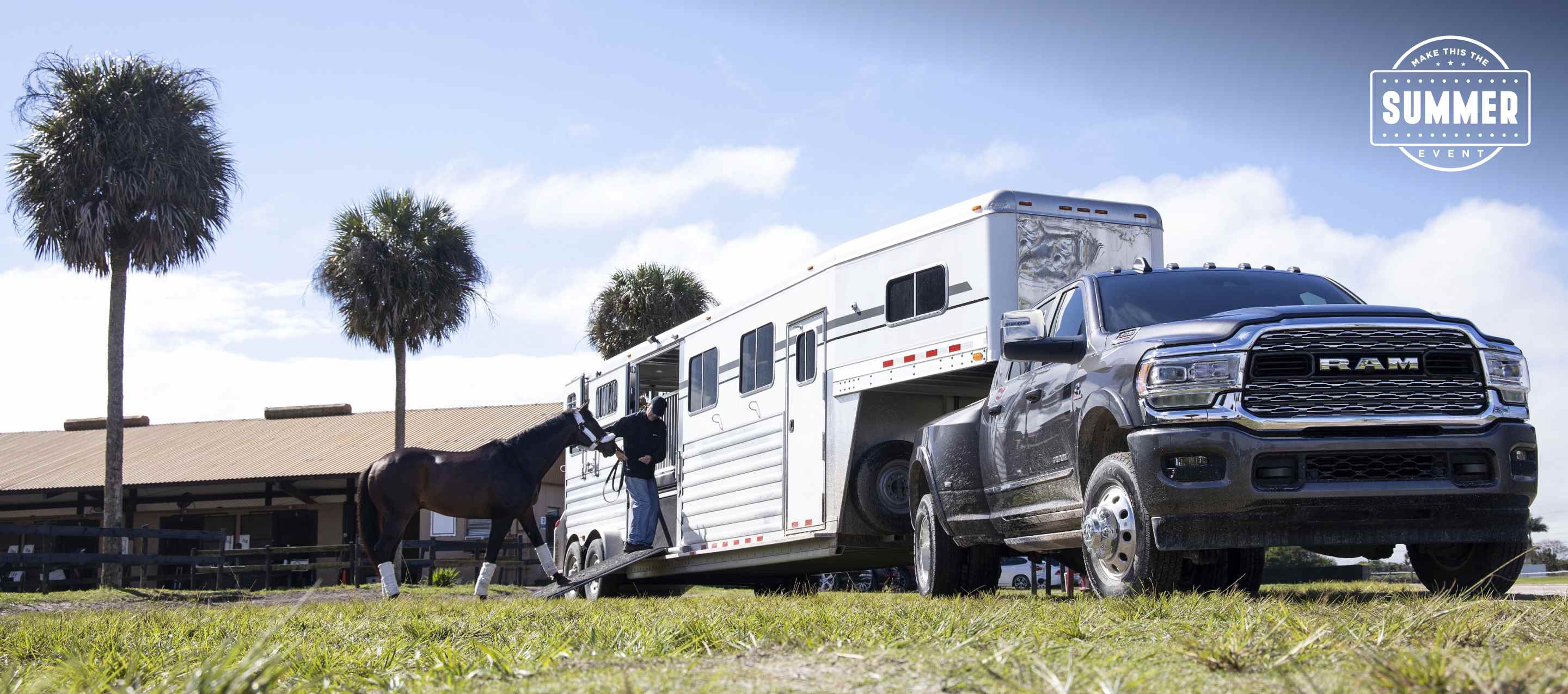 A 2024 Ram 3500 Limited Crew Cab towing a fifth wheel horse trailer with a man leading a horse into the trailer. Make This The Summer Event.