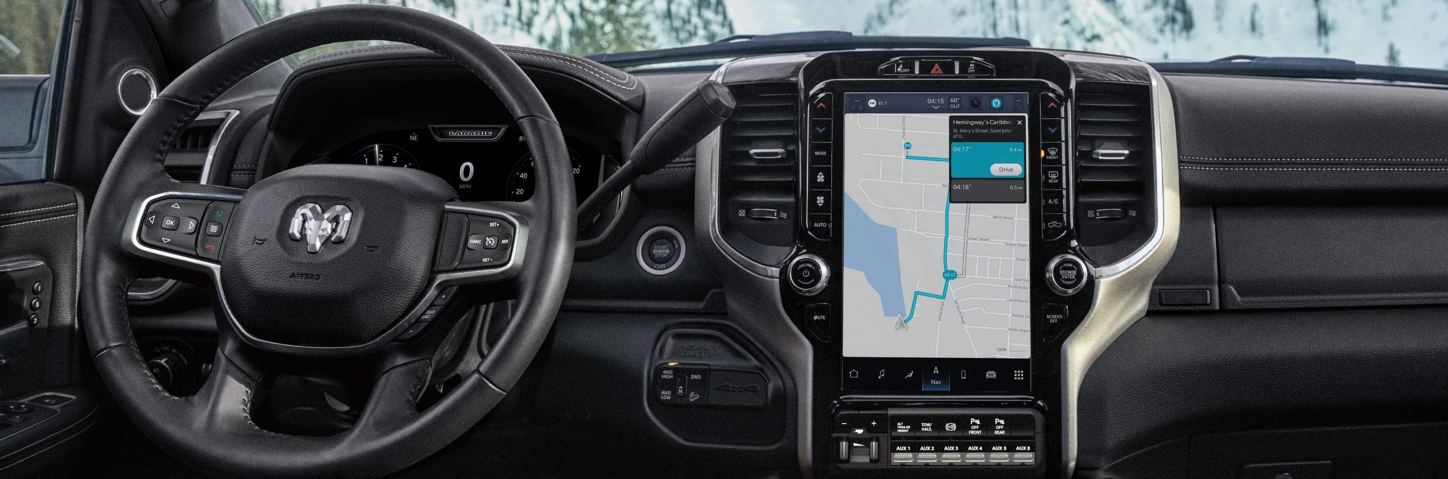 The interior of the 2024 Ram Limited Chassis Cab focusing on the steering wheel and Uconnect touchscreen, with the touchscreen displaying a navigation map.