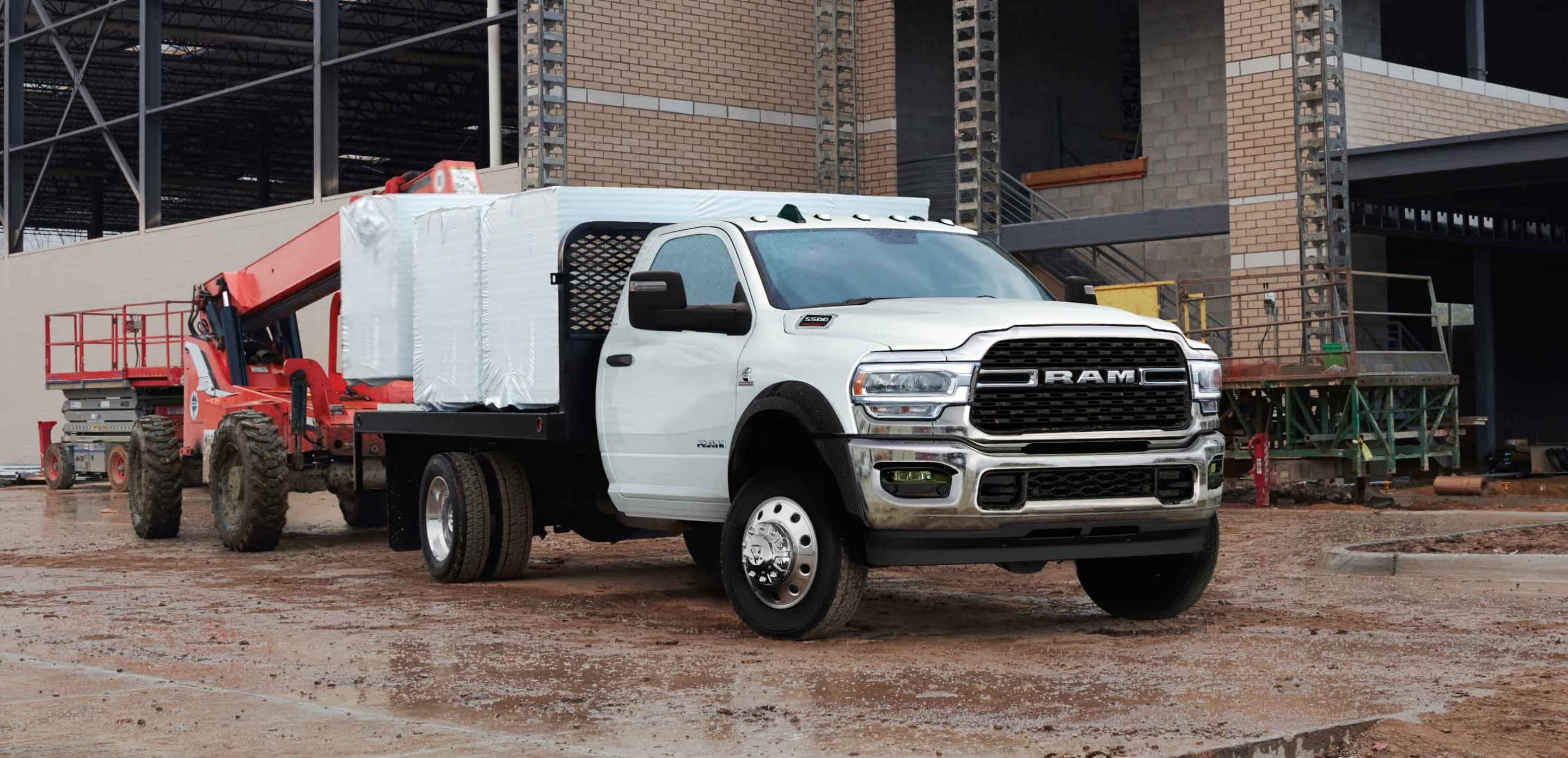 2025 Dodge RAM Chassis cab equipped one ton being loaded with pallets by a Telehandler forklift