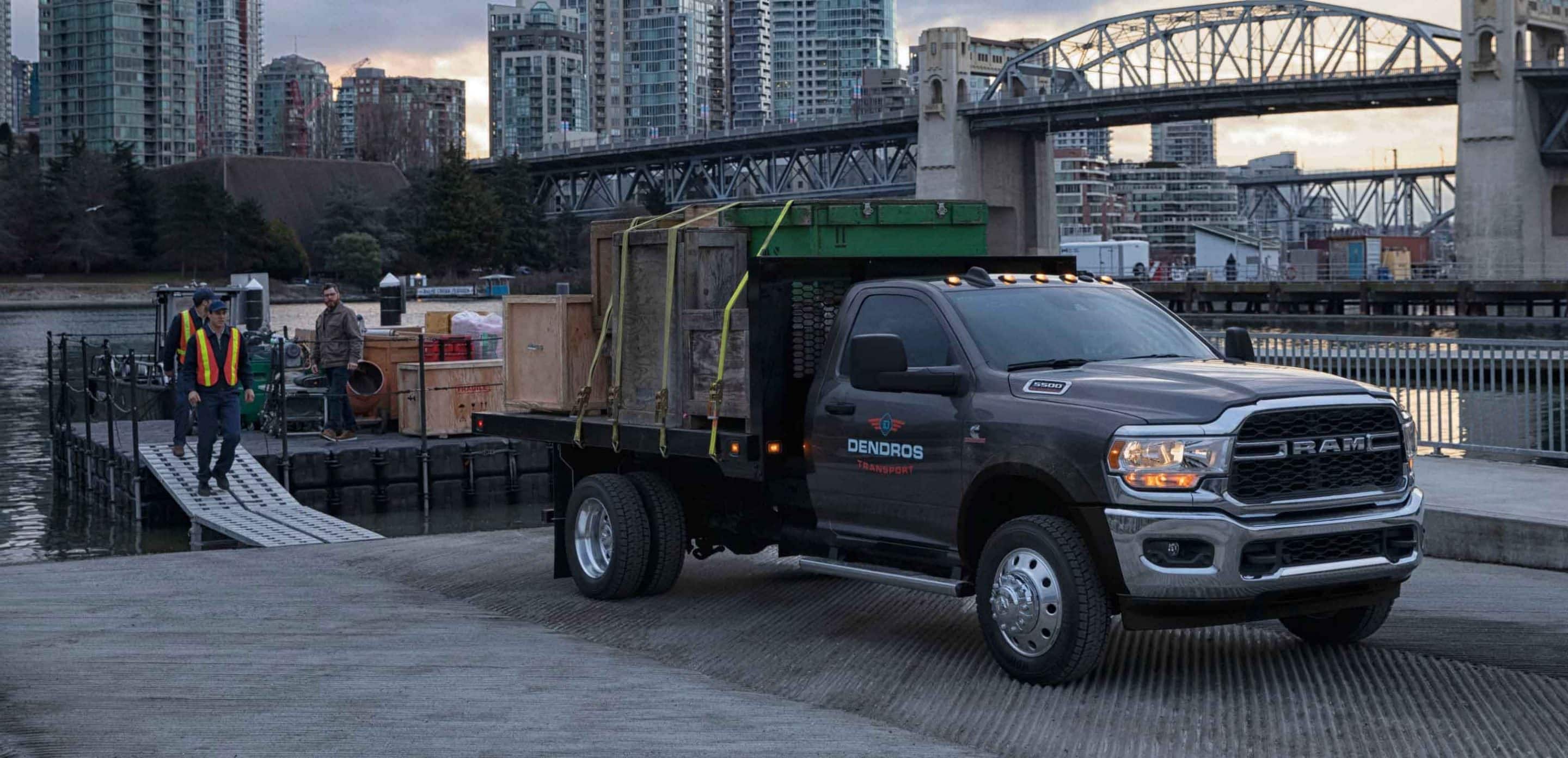 2024 RAM Chassis Cab hauling wooden crates from a cargo boat next to a canal