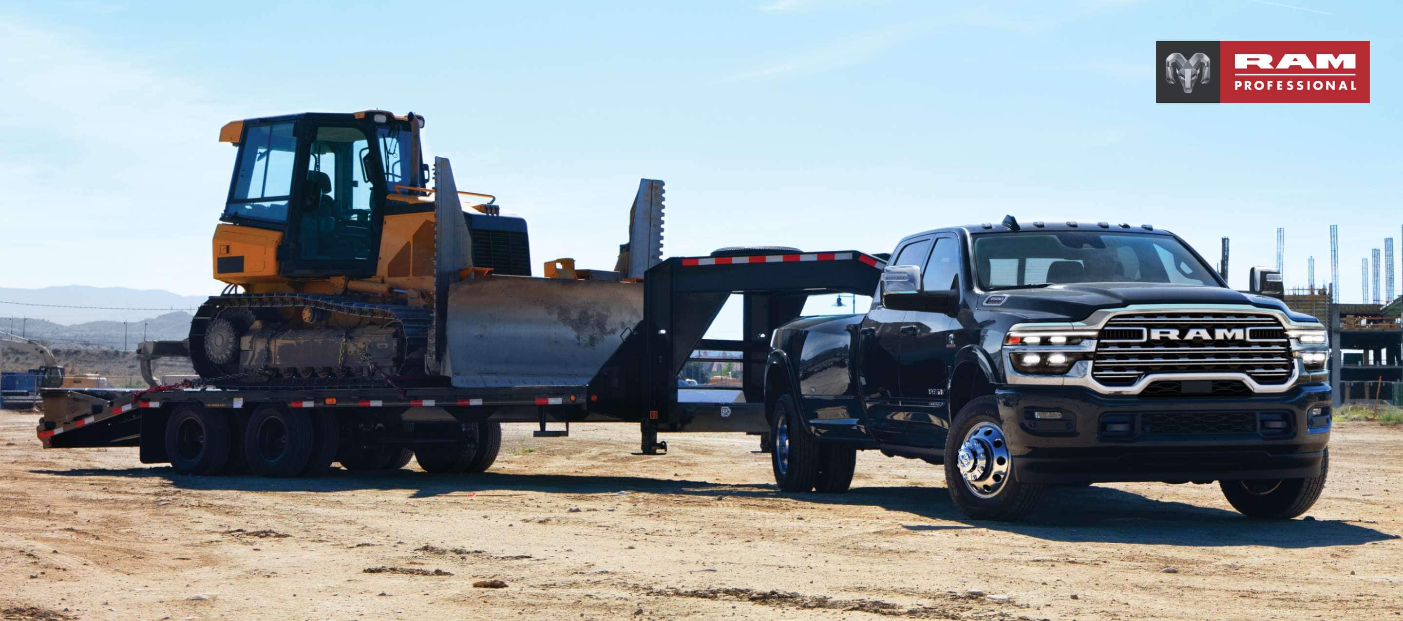 A black 2024 Ram 3500 Limited Crew Cab towing a fifth wheel flatbed trailer with an excavator on it. Ram Professional.